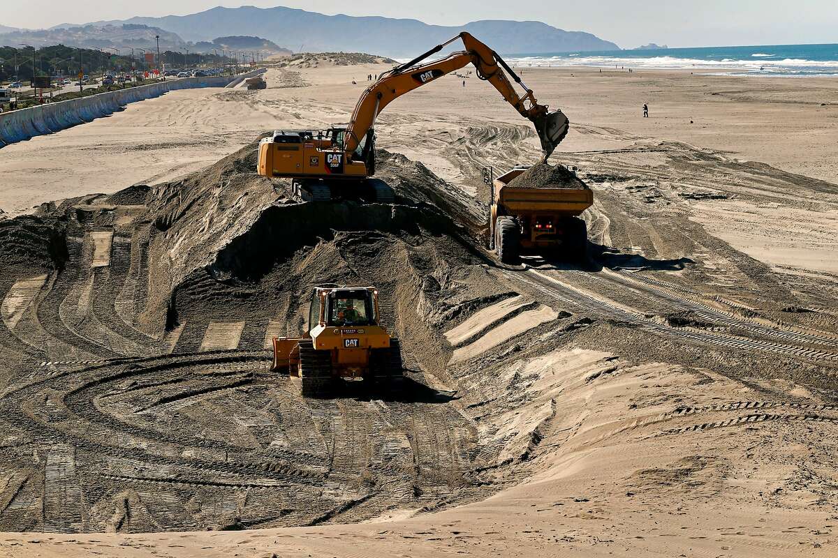 Huge dump trucks are filled with sand excavated from Ocean Beach near the Cliff House and transported to the other end to be used as erosion control in San Francisco, Calif. on Mon. Mar. 26, 2018. The San Francisco Public Utilities Commission is moving 50,000 cubic yards of sand around at Ocean Beach as a stopgap measure for the erosion along the south end of the shoreline.