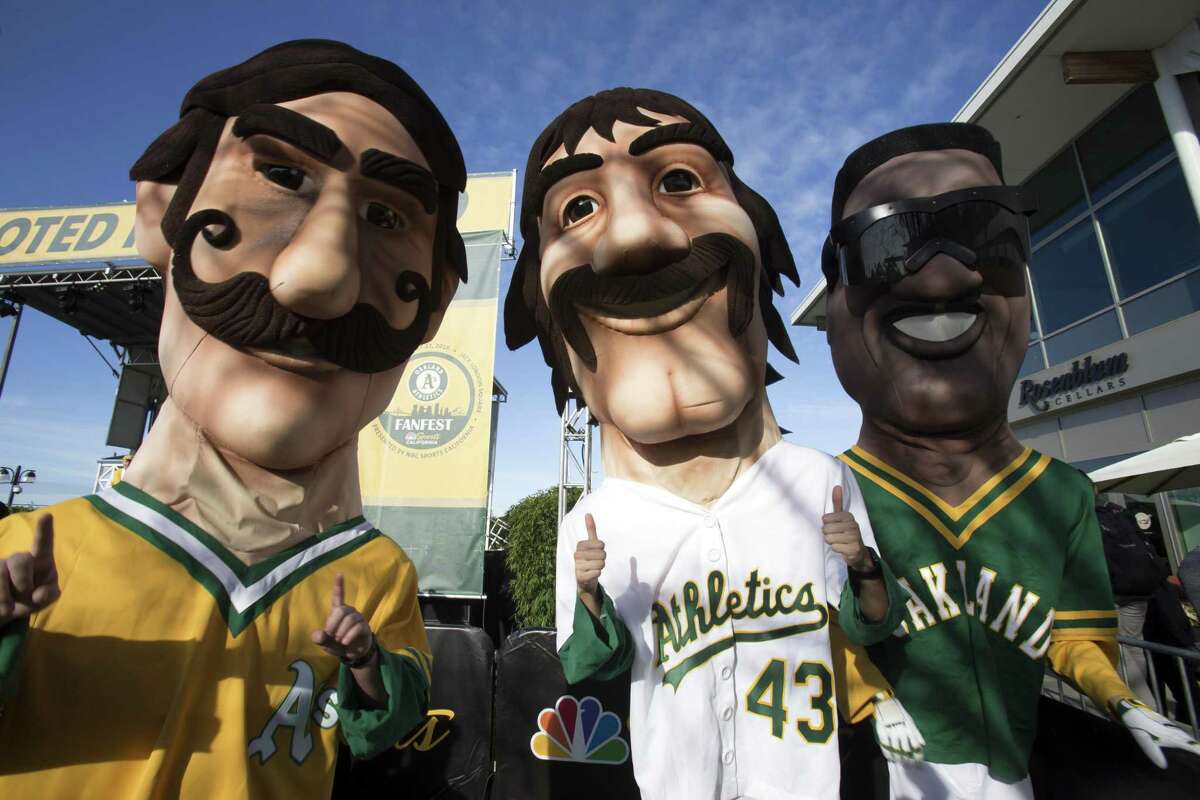 A's greats Rollie Fingers, from left, Dennis Eckersley and Rickey Henderson appear larger than life during Oakland Athletics Fan Fest at Jack London Square on Saturday, Jan. 27, 2018 in Oakland, Calif.