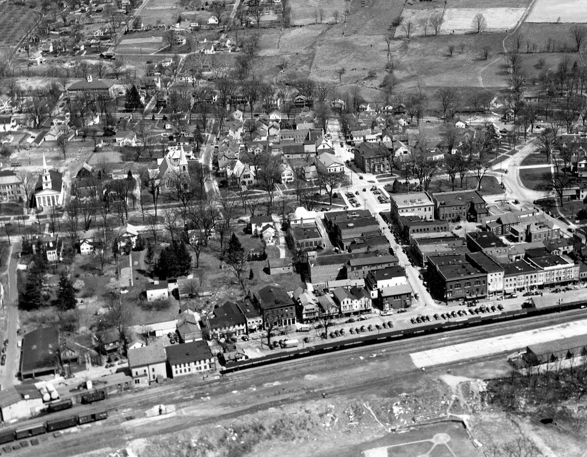 Courtesy of Roger Szendy SPECTRUM/An aerial photographb taken in the 1930s shows the New Milford village center with Young's Field in the foreground and the slopes leading up to Second Hill to the top. Note large homes line the west side of the Village Green along Main Street all the way north to Bennitt Street. For Way Back When 4/6/18