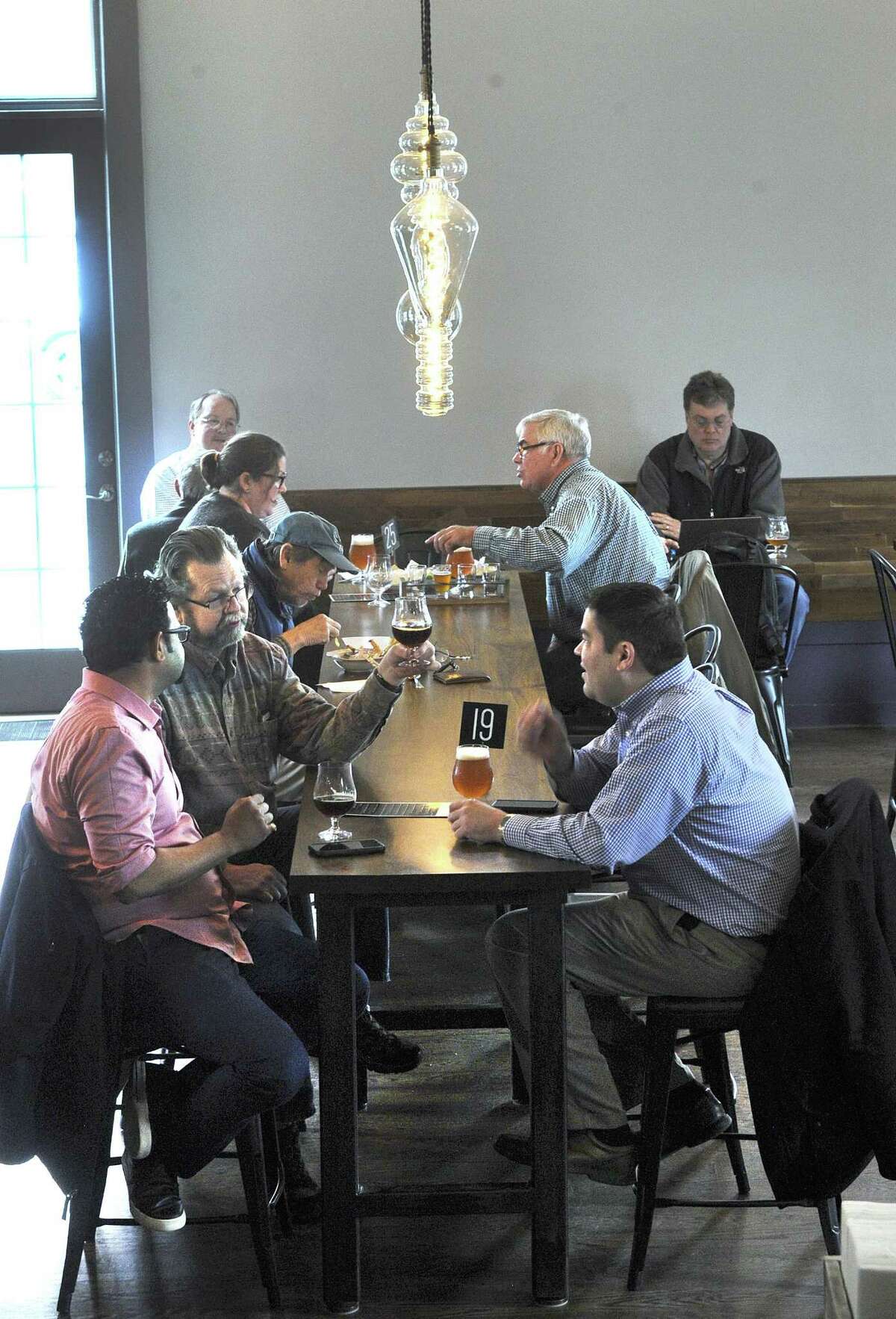 A lunch-time crowd at the Broken Symmetry Gastro Brewery in Bethel, which recently opened in a building that was once the Bethel Train Station. Photo Thursday, march 29, 2018.