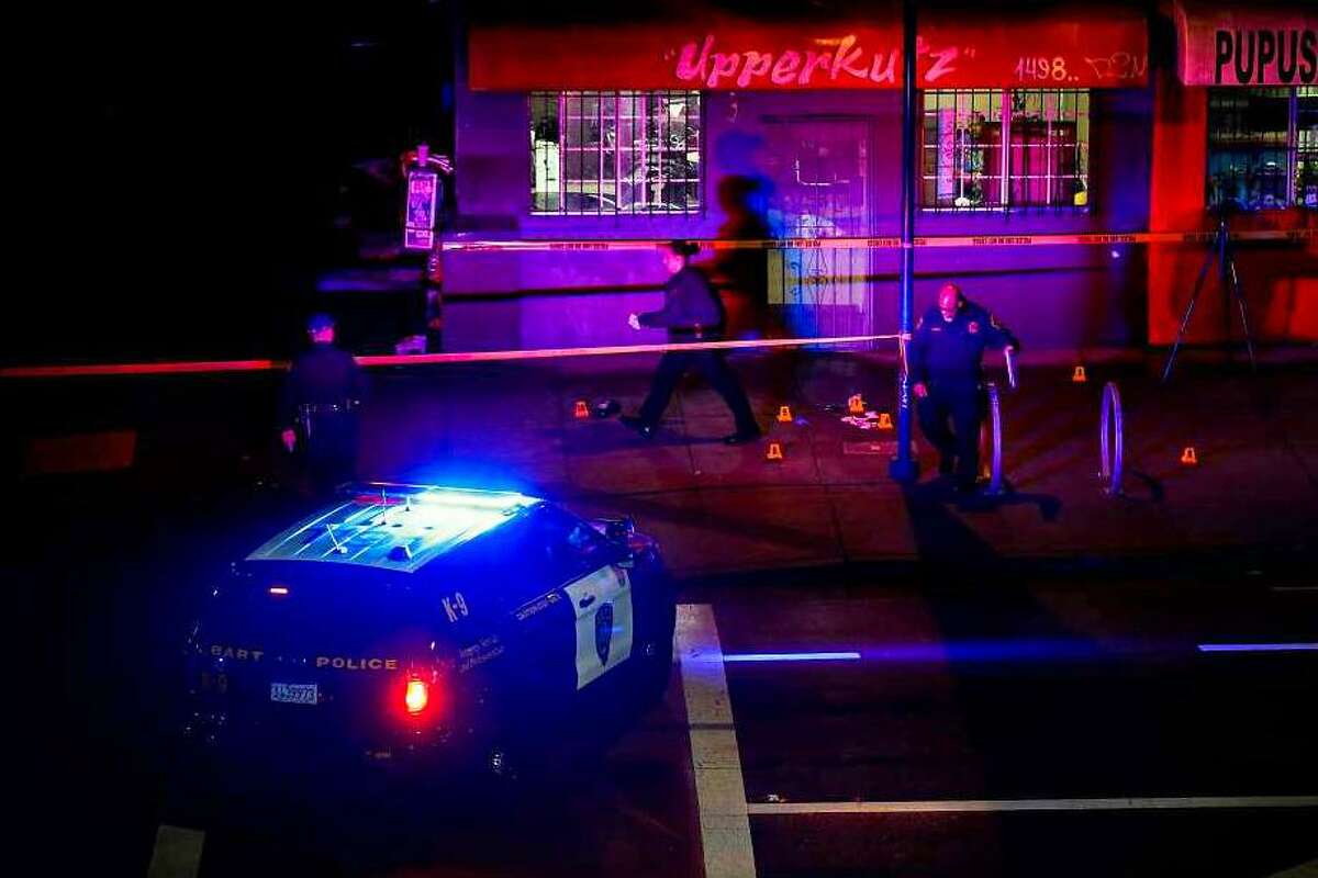 Police officers investigate outside barbershop Upperkutz on Seventh and Chester streets outside the West Oakland Bart station after a shooting in Oakland, Calif., on Wednesday, Jan. 3, 2018. Sahleem Tindle was killed by police during an incident involving another man.