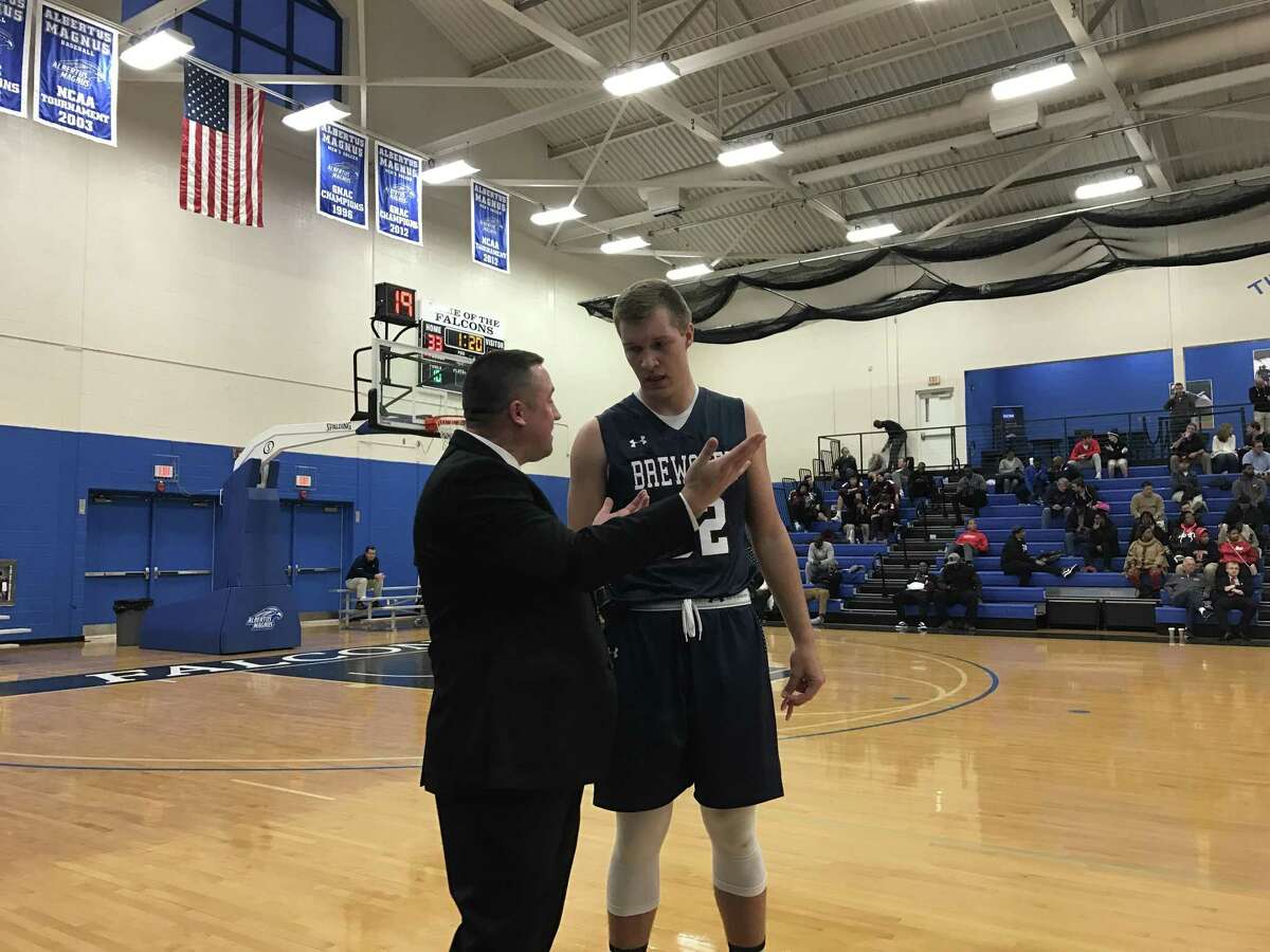 Lukas Kisunas, seen here with Brewster Academy coach Jason Smith at the National Prep Showcase, was released from his national letter of intent by UConn on Thursday.
