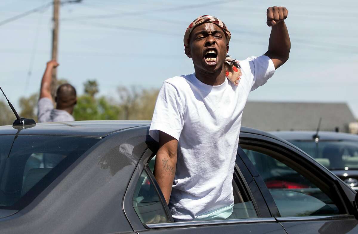 Ste’Vante Clark, brother of 22-year-old Stephon Clark who was shot and killed by Sacramento Police on March 18, chants his brother's name as he leaves Bayside of South Sacramento Church Thursday, March 29, 2018 in Sacramento, Calif. following Clark's funeral service.