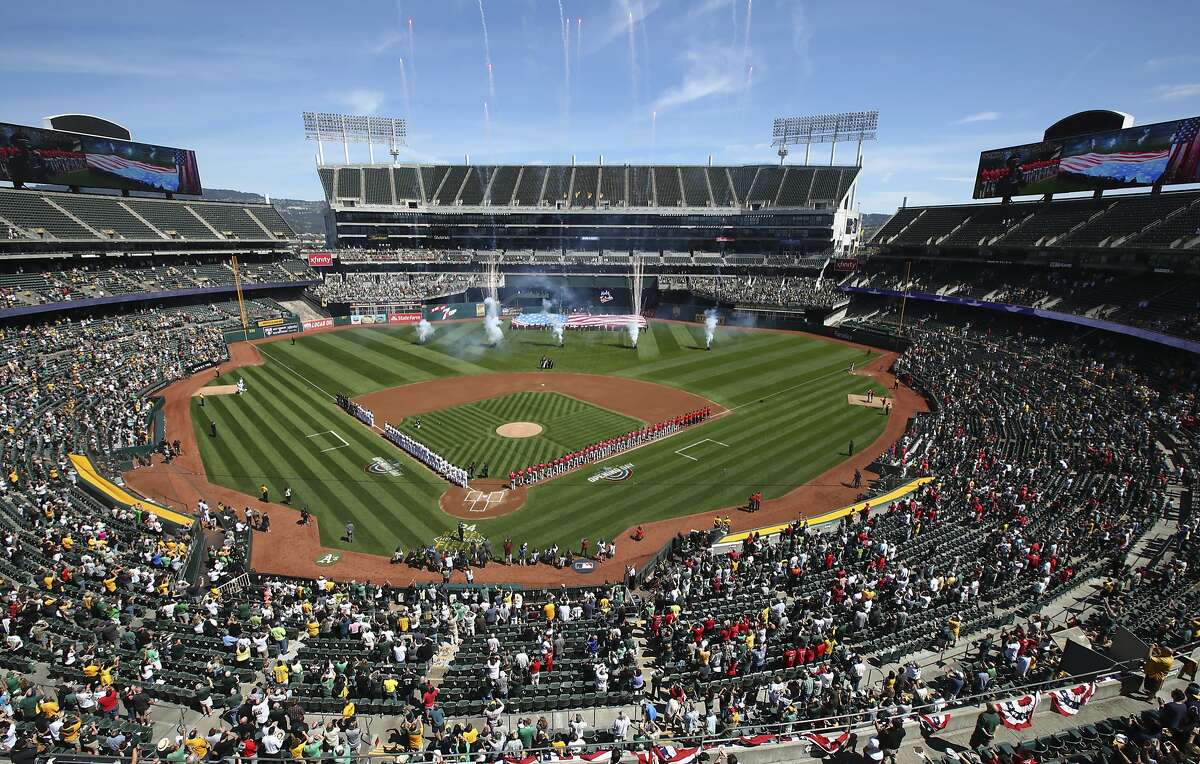 The Los Angeles Angels and the Oakland Athletics stand for the national anthem at Oakland Coliseum on Opening Day. 