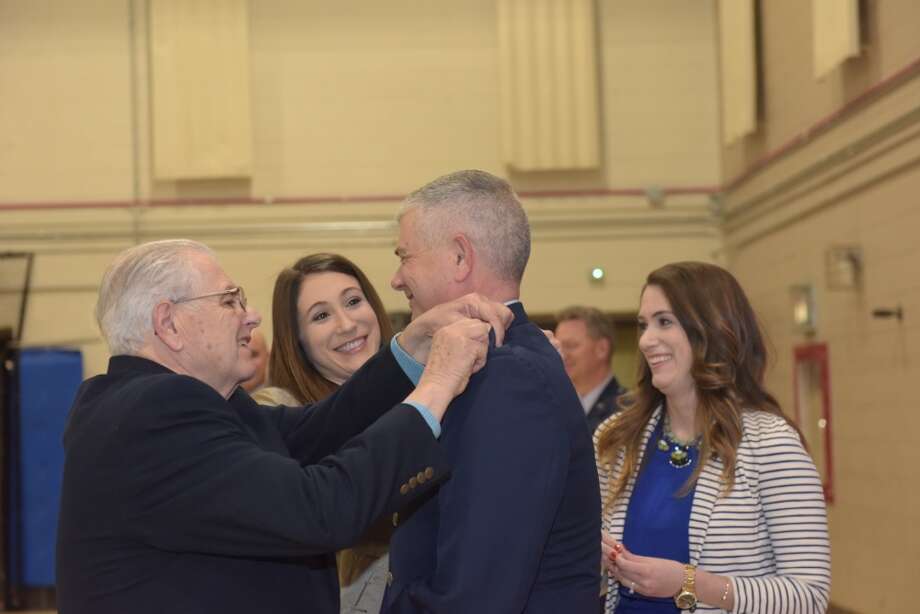 Retired Air Force Senior Master Sgt. Ken Clouthier, left, pins the new one star rank of brigadier general on the uniform of his son, Shawn Clouthier, during his promotion ceremony as Shawn Clouthier’s daughters Alexa, center, and Tori, right look on in Latham, N.Y., March 21, 2018. Clouthier, the former commander of the 109th Airlift Wing, now serves as the Assistant Adjutant General for the New York Air National Guard. Photo: U.S. Air National Guard Photo By Master Sgt. Willie Gizara, 109th Airlift Wing