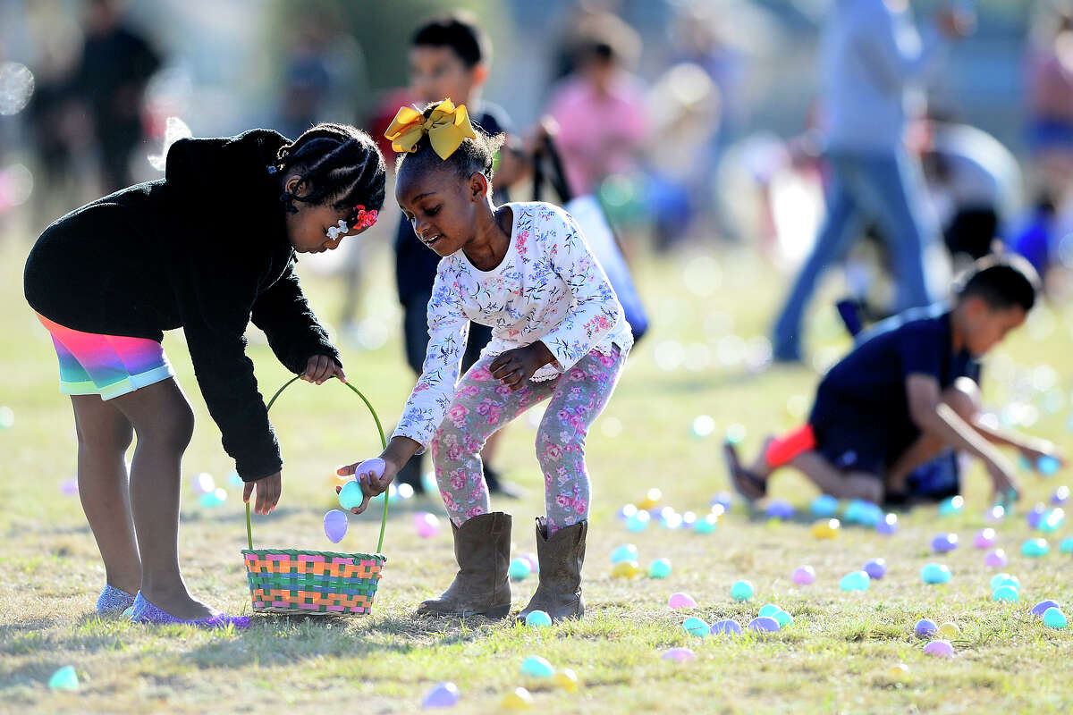 Suri Springer, left, gathers easter eggs with her sister Serenity Hearst, right, during the City of Midland's "Easter Eggstravaganza" March 29, 2018, at MLK Park. James Durbin/Reporter-Telegram
