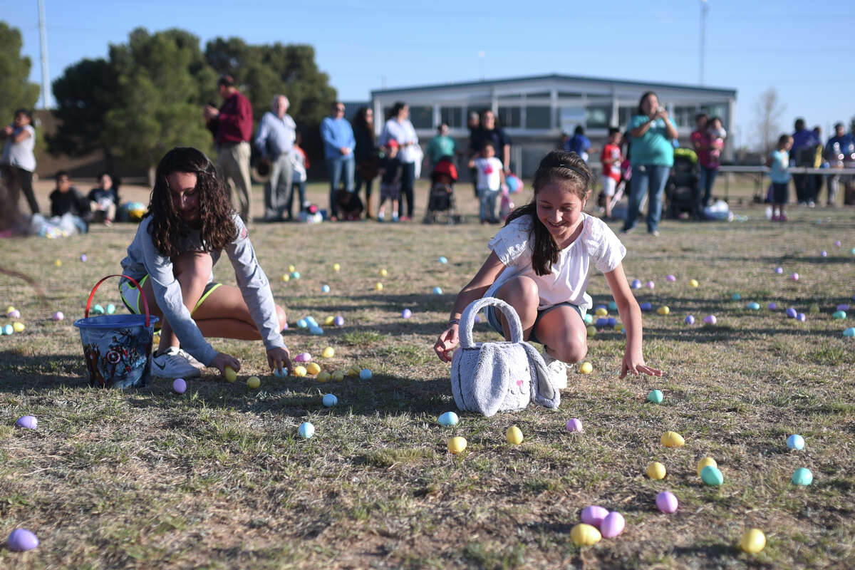 Children gather easter eggs during the City of Midland's "Easter Eggstravaganza" March 29, 2018, at MLK Park. James Durbin/Reporter-Telegram