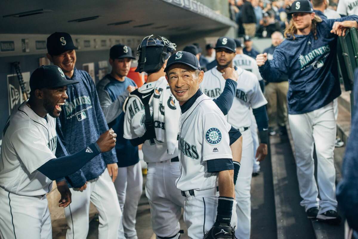 Famed hitter and returned Mariner Ichiro Suzuki smiles in the dugout before the Mariners take to the field for the first inning of their 2018 season, at Safeco Field on Thursday, March 29, 2018.(GRANT HINDSLEY, seattlepi.com)