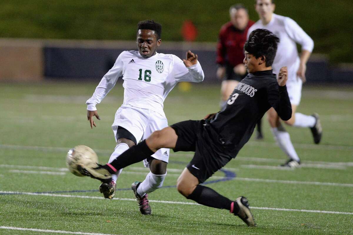 Angel Originales (3) of Spring Woods makes a slide tackle to steal the ball from Chris Kalwahali (16) of Stratford during the first half of a boys high school soccer game between the Stratford Spartans and the Spring Woods Tigers on Tuesday, March 7, 2017 at Tulley Stadium, Houston, TX.
