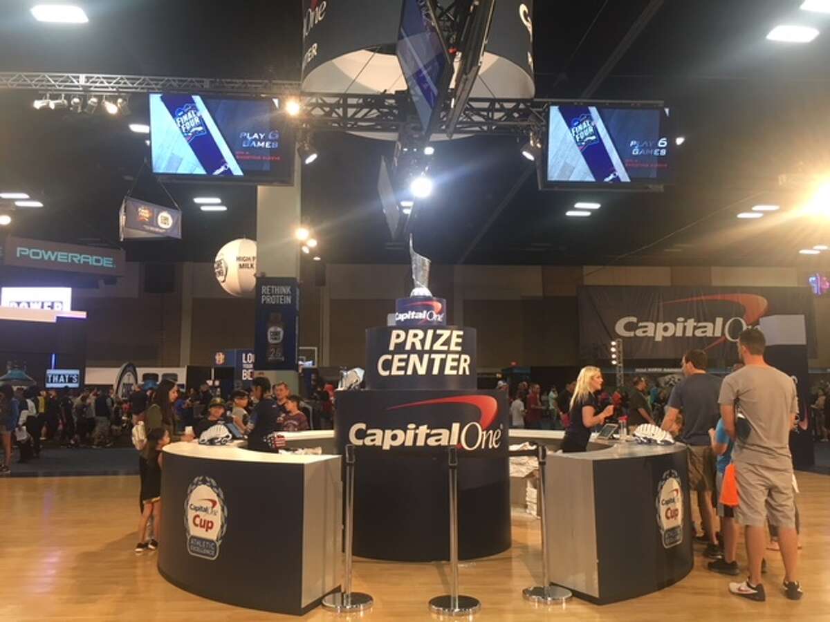 Capital One's Cup Challenge Prize Center Fan Fest guests check in at the Prize Center to receive a player card which will keep track of interactive game scores. The more Capital One-sponsored games a person plays, the more swag they will score.
