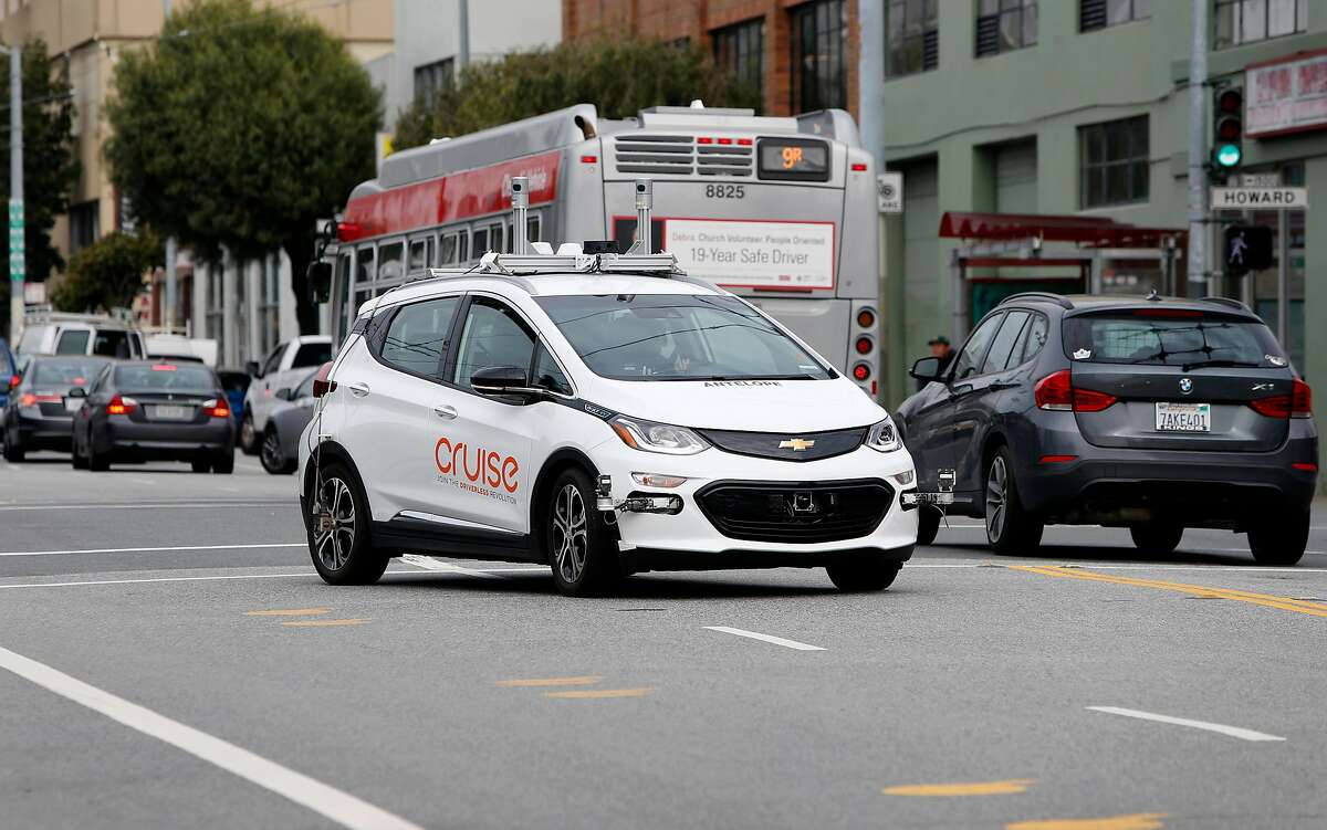 A Cruise self-driving car goes along 11th Street in San Francisco in 2017. Autonomous vehicles contain the car and driver in a single package, creating some regulatory ambiguity between the federal government and the states.
