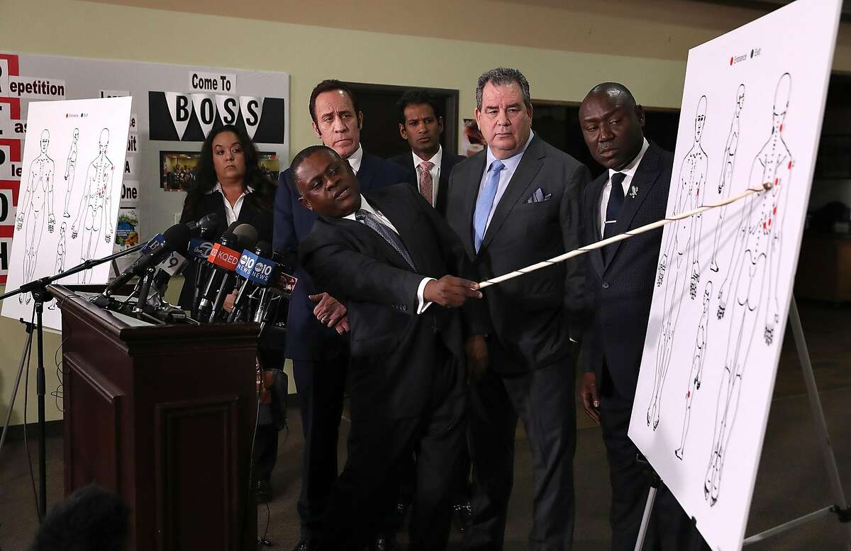 SACRAMENTO, CA - MARCH 30: (L-R) Dr. Bennet Omalu, attorney Dale Galipo, attorney Brian Panish and attorney Ben Crump examine a diagram showing gunshot wounds to Stephon Clark during a news conference at the Southside Christian Center on March 30, 2018 in Sacramento, California. The legal team for the family of Stephon Clark, who was shot and killed by Sacramento police, held a news conference to announce their findings of an independent autopsy performed by renowned forensic pathologist Dr. Bennet Omalu. The autopsy showed that Clark was shot eight times. (Photo by Justin Sullivan/Getty Images)