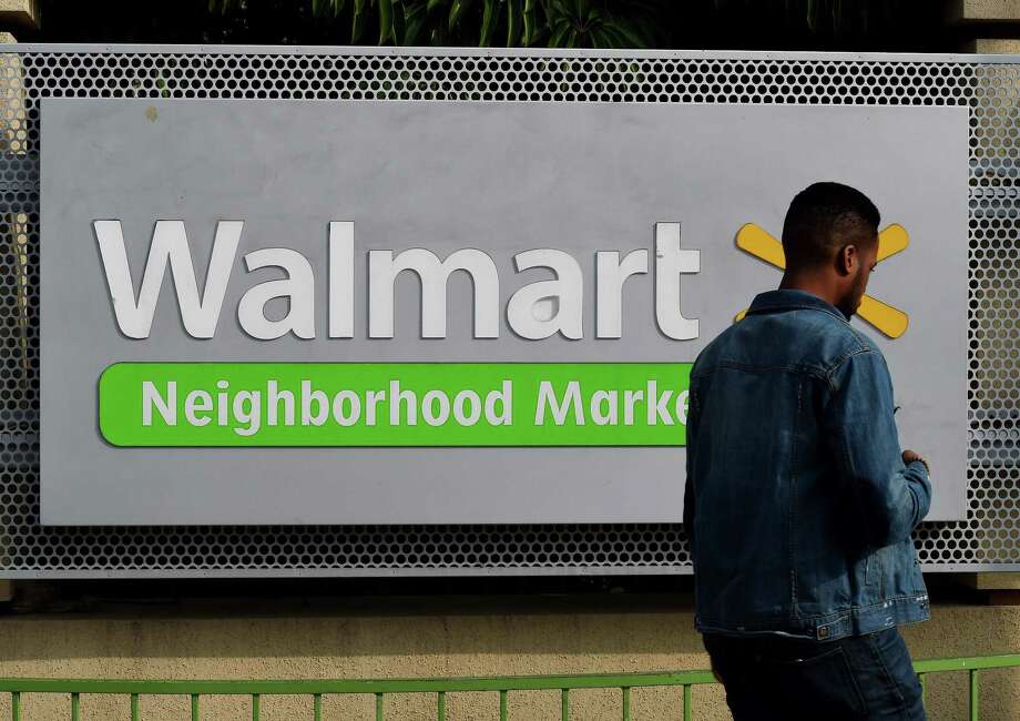 (FILES) This file photo taken on January 16, 2016 shows a manwalking past a Walmart store in Chinatown, Los Angeles.
US retail behemoth Walmart is in preliminary talks to acquire health insurer Humana, the Wall Street Journal reported late on March 29, 2018. / AFP PHOTO / MARK RALSTONMARK RALSTON/AFP/Getty Images Photo: MARK RALSTON / AFP or licensors