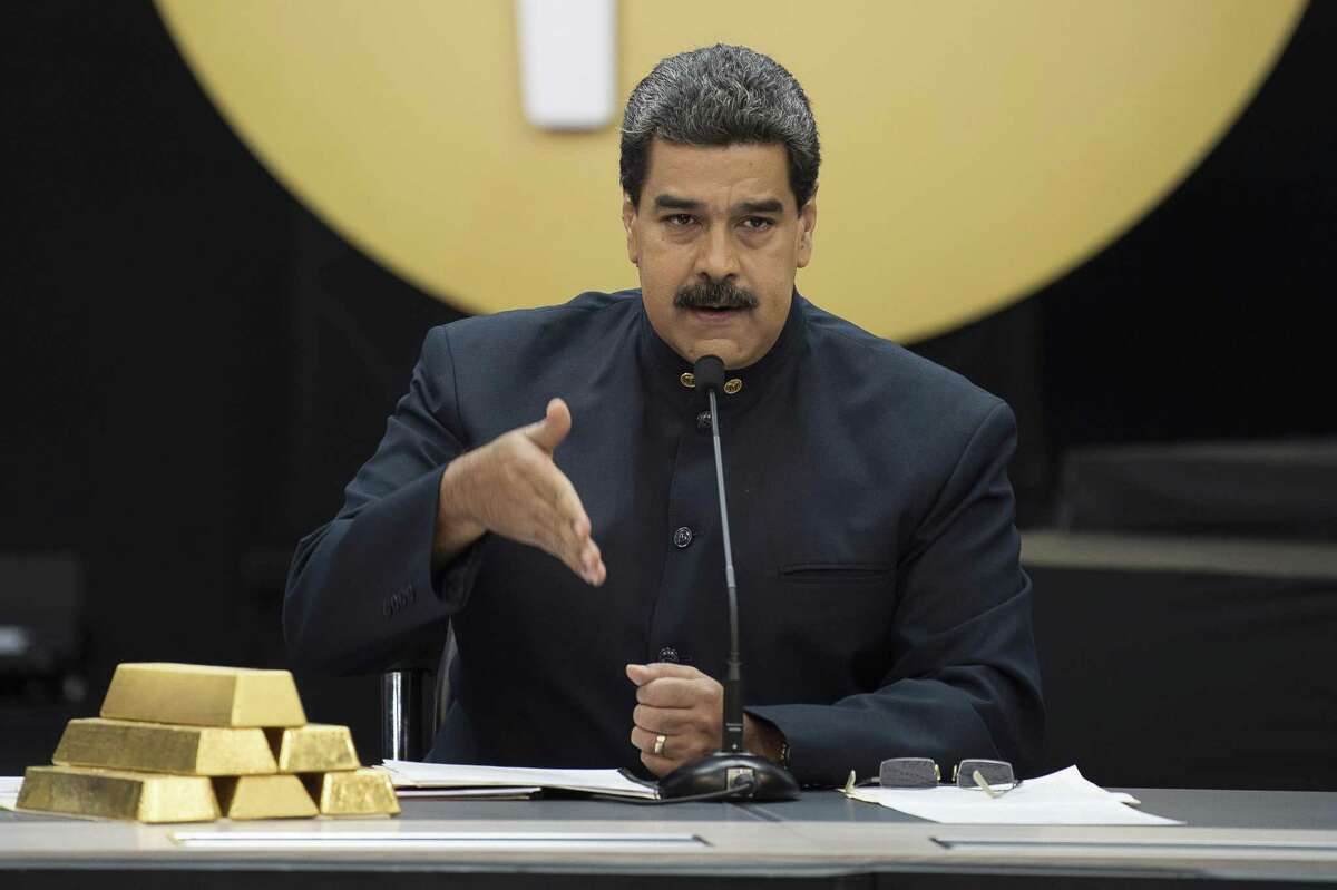 Nicolas Maduro, Venezuela's president, speaks next to a stack of 12 Kilogram gold ingots during a news conference on the country's cryptocurrency, known as the Petro, in Caracas, Venezuela, on Thursday, March 22, 2018. U.S. President Trump banned U.S. purchases of the Petro as part of a campaign to pressure the government of Maduro. Photographer: Carlos Becerra/Bloomberg