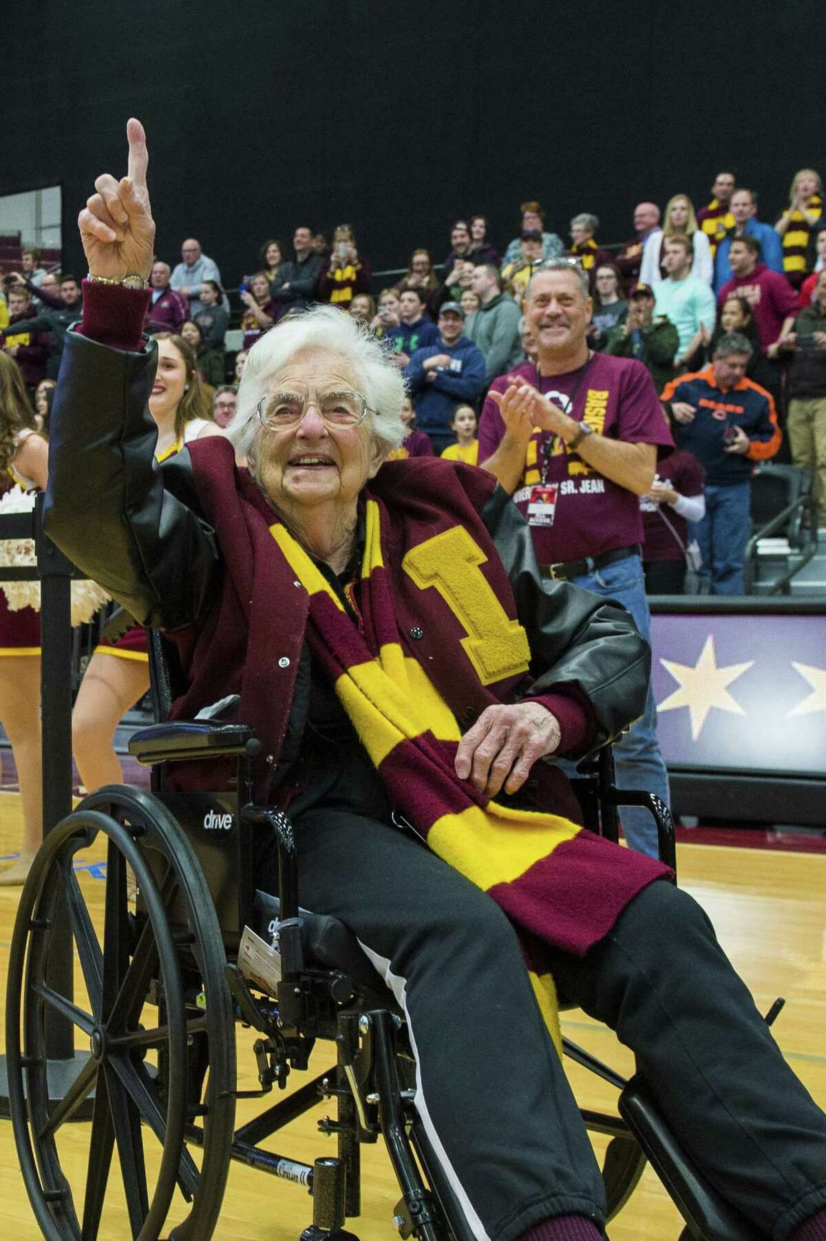 Sister Jean Dolores-Schmidt, the Loyola Ramblers Chaplain, holds up number one as fans chant inside the Gentile Arena in Chicago. 