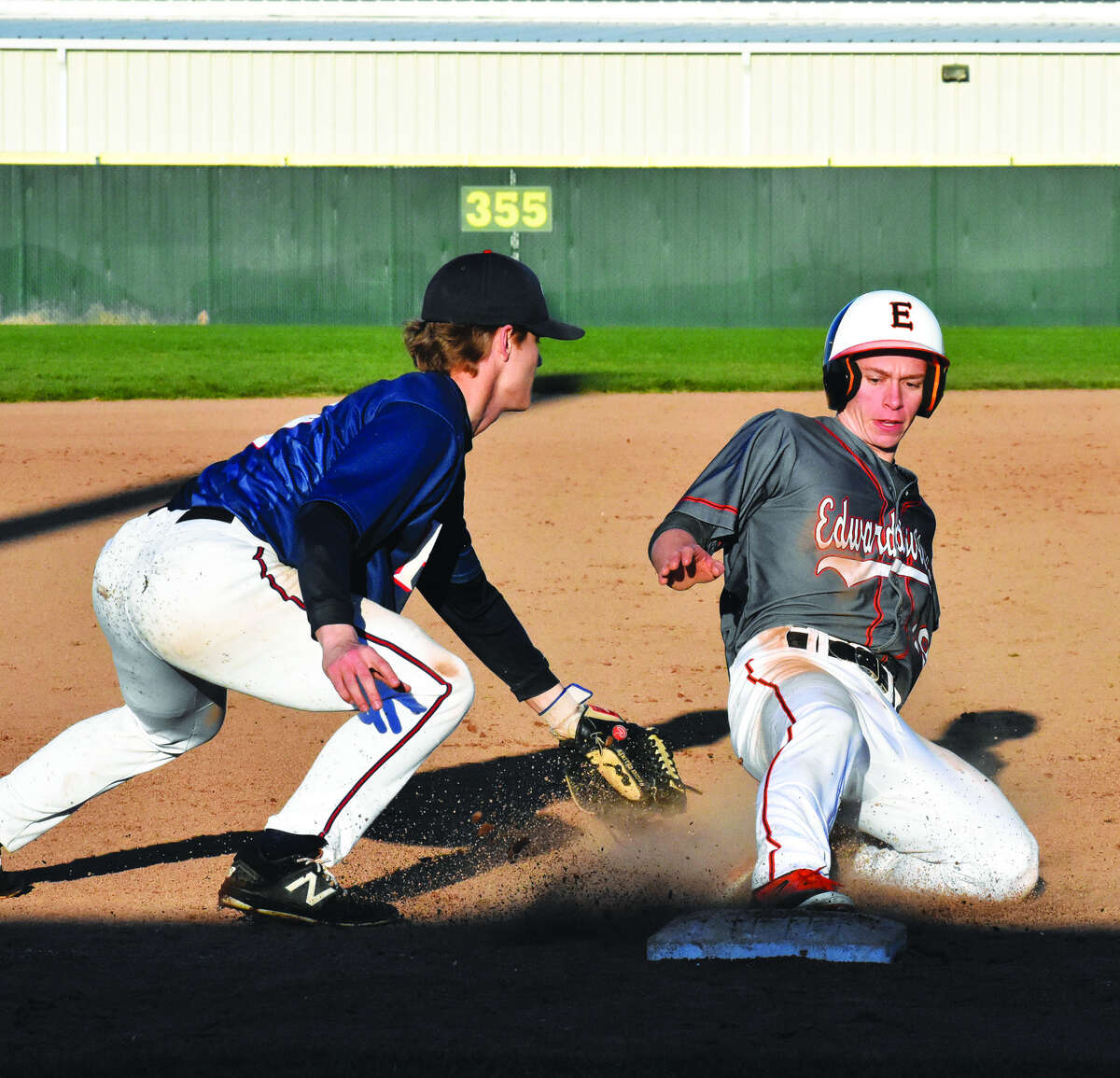 Edwardsville’s Aaron Young, right, slides safely into third base during the fifth inning against Parkway South.