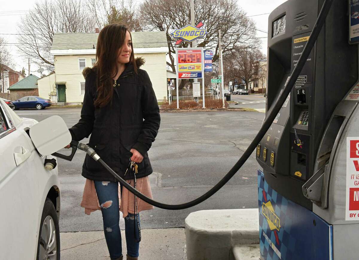 Melissa Ferrara of Watervliet fills her gas tank at a Xtramart Sunoco station on Friday, March 30, 2018 in Watervliet, N.Y. Global Partners operates a dozen or more stores in the Capital Region. Its convenience store brands include XtraMart, Mr. Mike's and Fast Freddie's. (Lori Van Buren/Times Union)