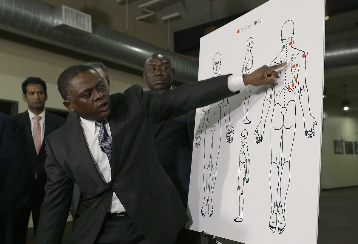 Pathologist Dr. Bennet Omalu points to details in a diagram showing the gunshot wounds he found on the body of Stephon Clark who was shot by Sacramento police, during a news conference Friday, March 30, 2018, in Sacramento, Calif. Omalu was hired by the attorneys of the Clark family to perform the independent autopsy. (AP Photo/Rich Pedroncelli)