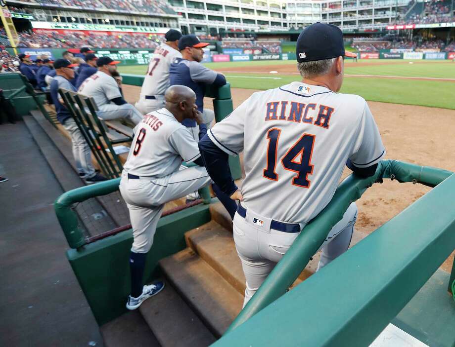 houston astros manager aj hinch (14) stands in the dugout in the