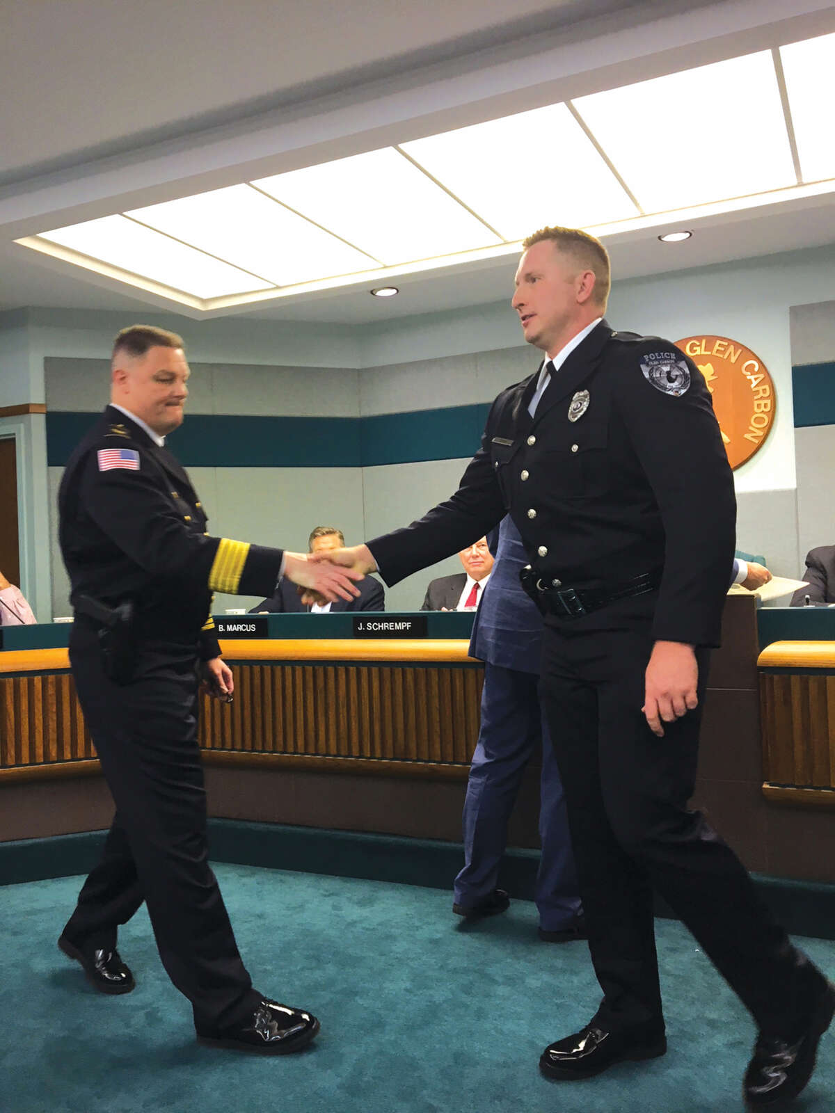 Glen Carbon Police Chief Todd Link, left, congratulates Officer Justin Click who was promoted to the rank of sergeant in the Glen Carbon Police Department. Click has been with the department since 2011