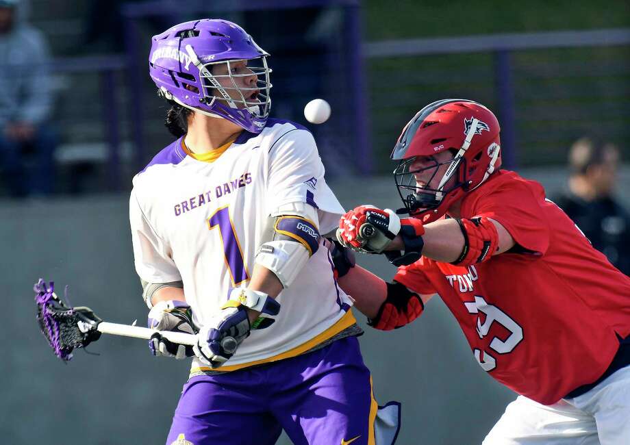 University at Albany's Tehoka Nanticoke (1) passes the ball behind his back against Stony Brook defender Danny Cassidy (99) during a NCAA Division I college men's lacrosse game on Saturday, March 31, 2018, in Albany, N.Y. (Hans Pennink / Special to the Times Union) Photo: Hans Pennink / Hans Pennink