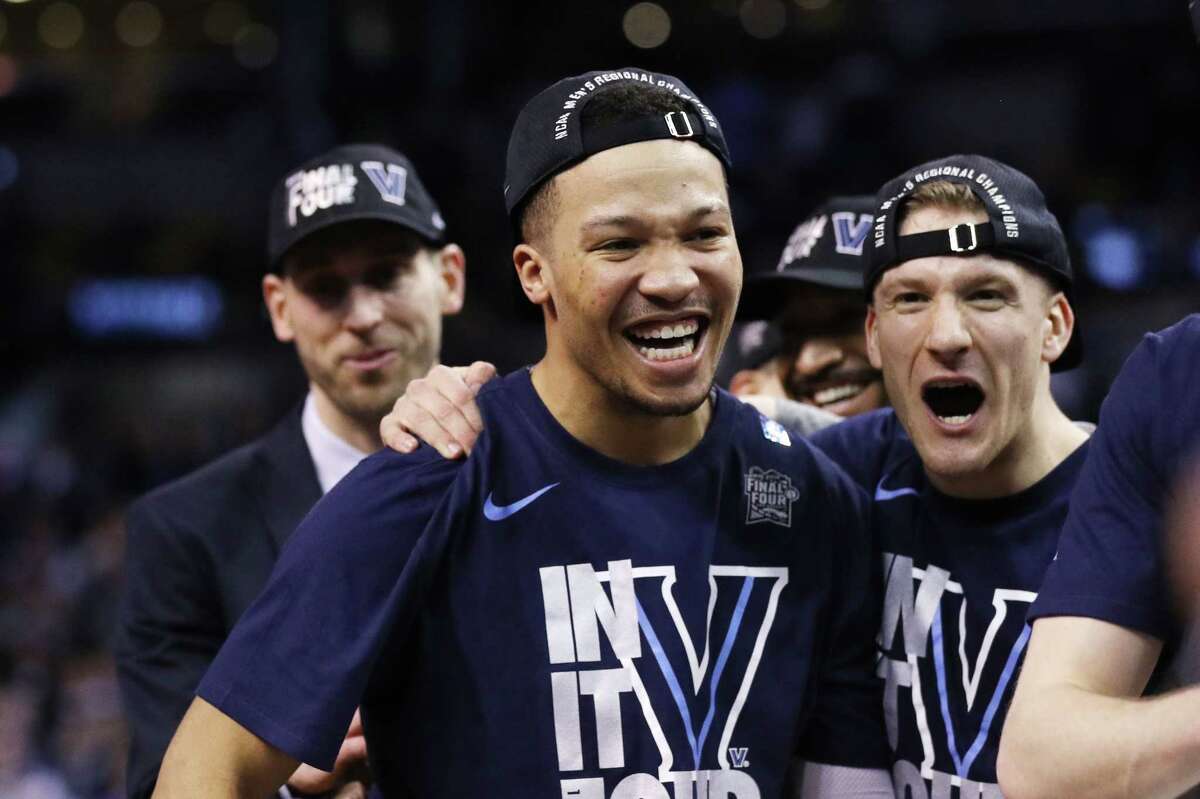BOSTON, MA - MARCH 25: Jalen Brunson #1 and Matt Kennedy #35 of the Villanova Wildcats celebrate after defeating the Texas Tech Red Raiders 71-59 in the 2018 NCAA Men's Basketball Tournament East Regional at TD Garden on March 25, 2018 in Boston, Massachusetts.