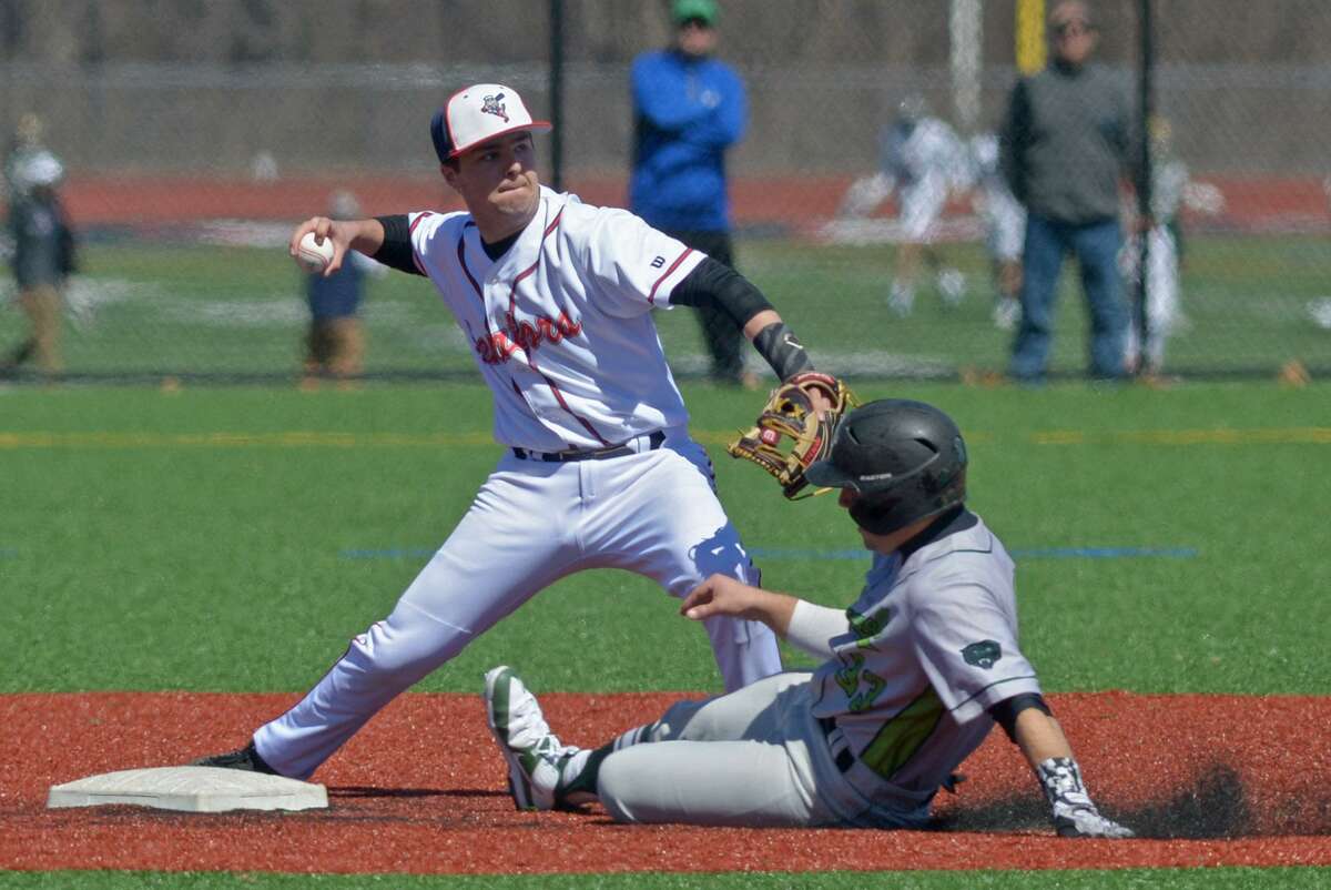 Norwalk High School Bears baserunner Marco Monteiro slides into second base as Brien McMahon’s Cooper Grillo looks to turn a double play during their intra-city baseball game Saturday, March 31, at Brien McMahon High Schooll in Norwalk, Conn.