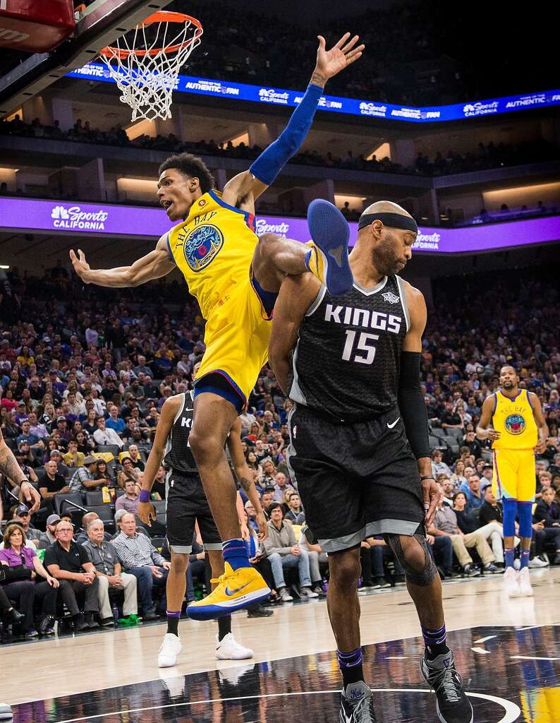 The Sacramento Kings' Vince Carter (15) turns away as the Golden State Warriors' Patrick McCaw (0) falls in the third quarter after he was fouled at the Golden 1 Center in Sacramento, Calif., on Saturday, March 31, 2018. McCaw was injured on the play and left the court on a stretcher. (Hector Amezcua/Sacramento Bee/TNS) Photo: Hector Amezcua, TNS