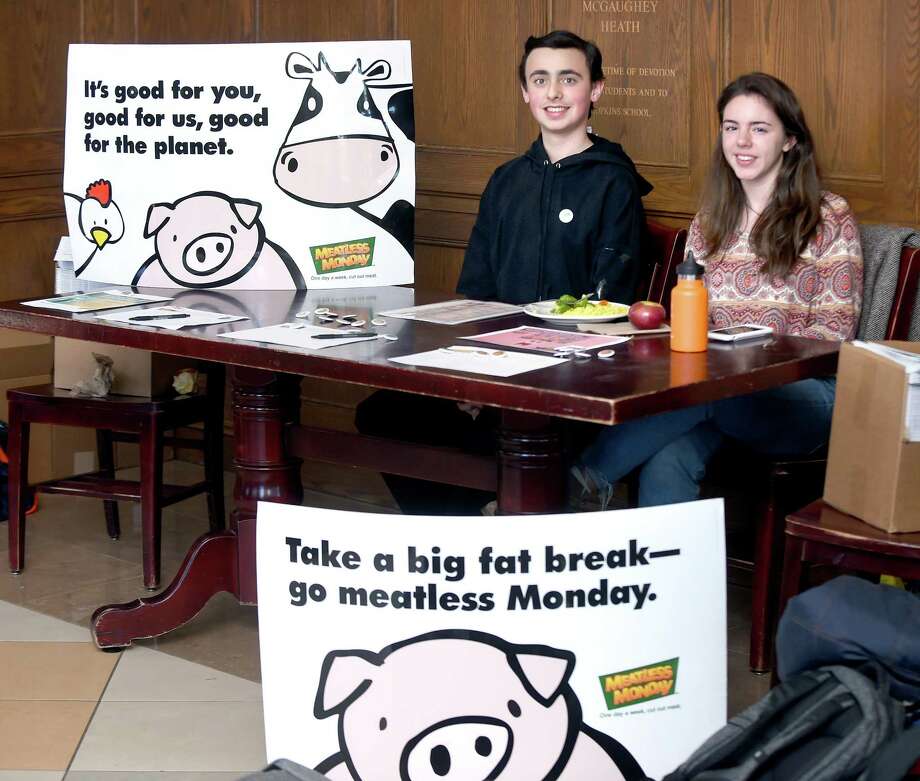 Freshmen Jack Kealey, left, and Sophie Sonnenfeld outside of the Heath Dining Room where they are encouraging classmates to sign a meatless pledge at Hopkins School in New Haven on Monday. Photo: Arnold Gold / Hearst Connecticut Media / New Haven Register