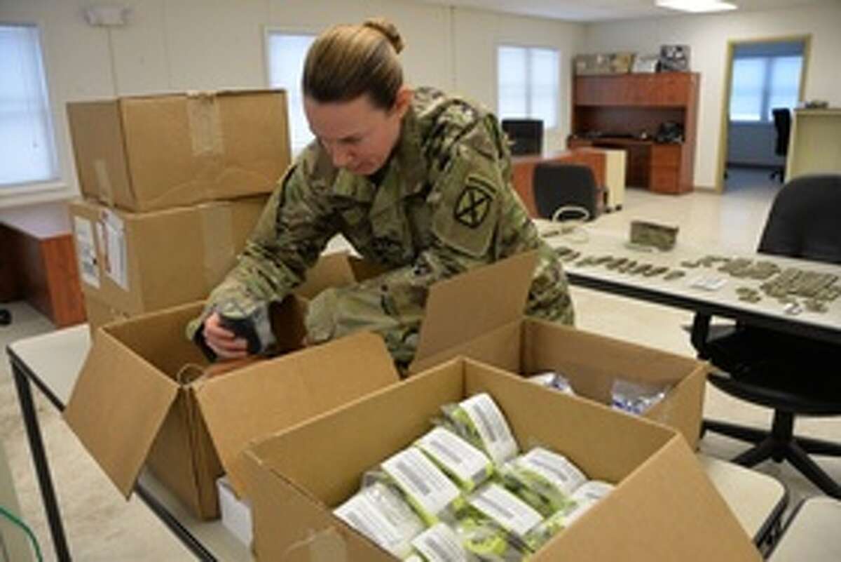 New York Army National Guard 1st. Lt. Victoria Lovett, a member of the 10th Mountain Division Main Command Post-Operational Detachment, sets up an office during pre-deployment training at Fort Drum. (New York Army National Guard)