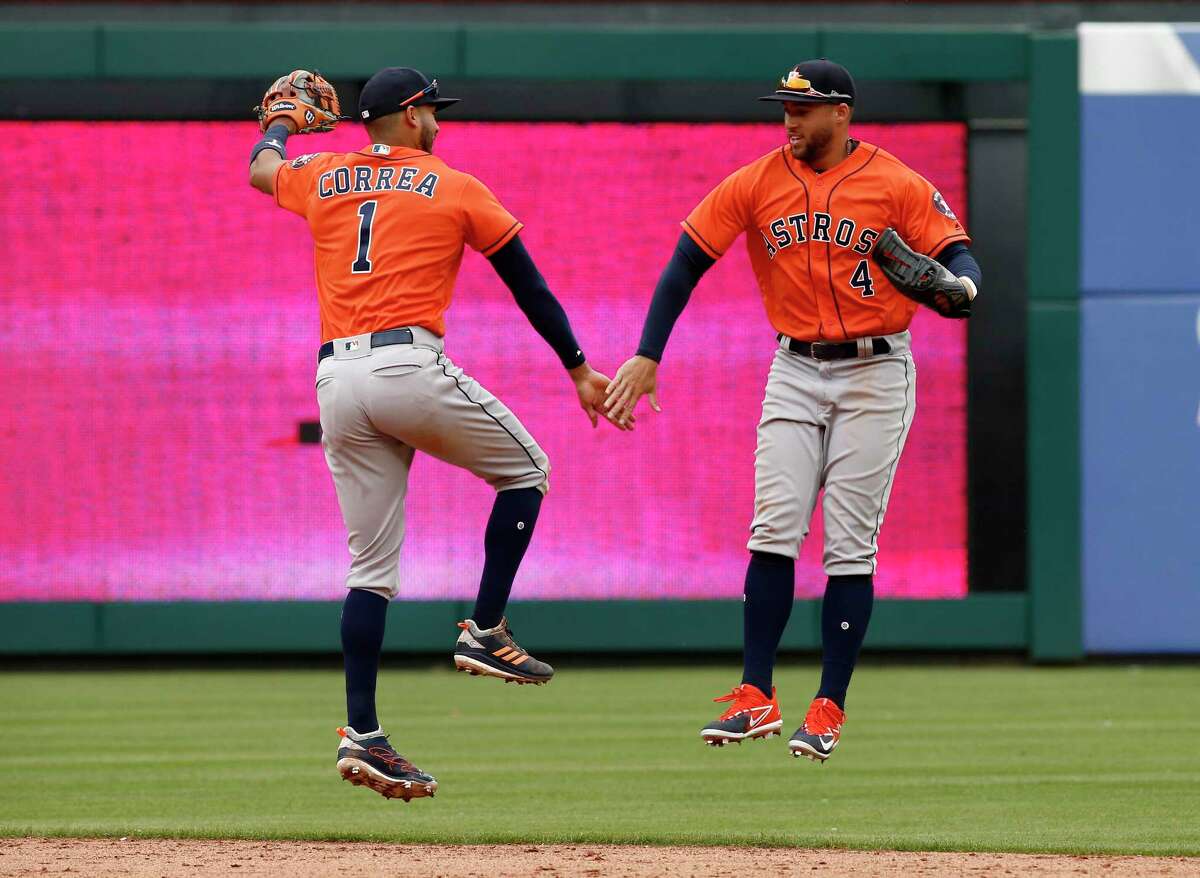 Houston Astros' George Springer (4) celebrates with catcher Evan Gattis  (11) after beating the Los Angeles