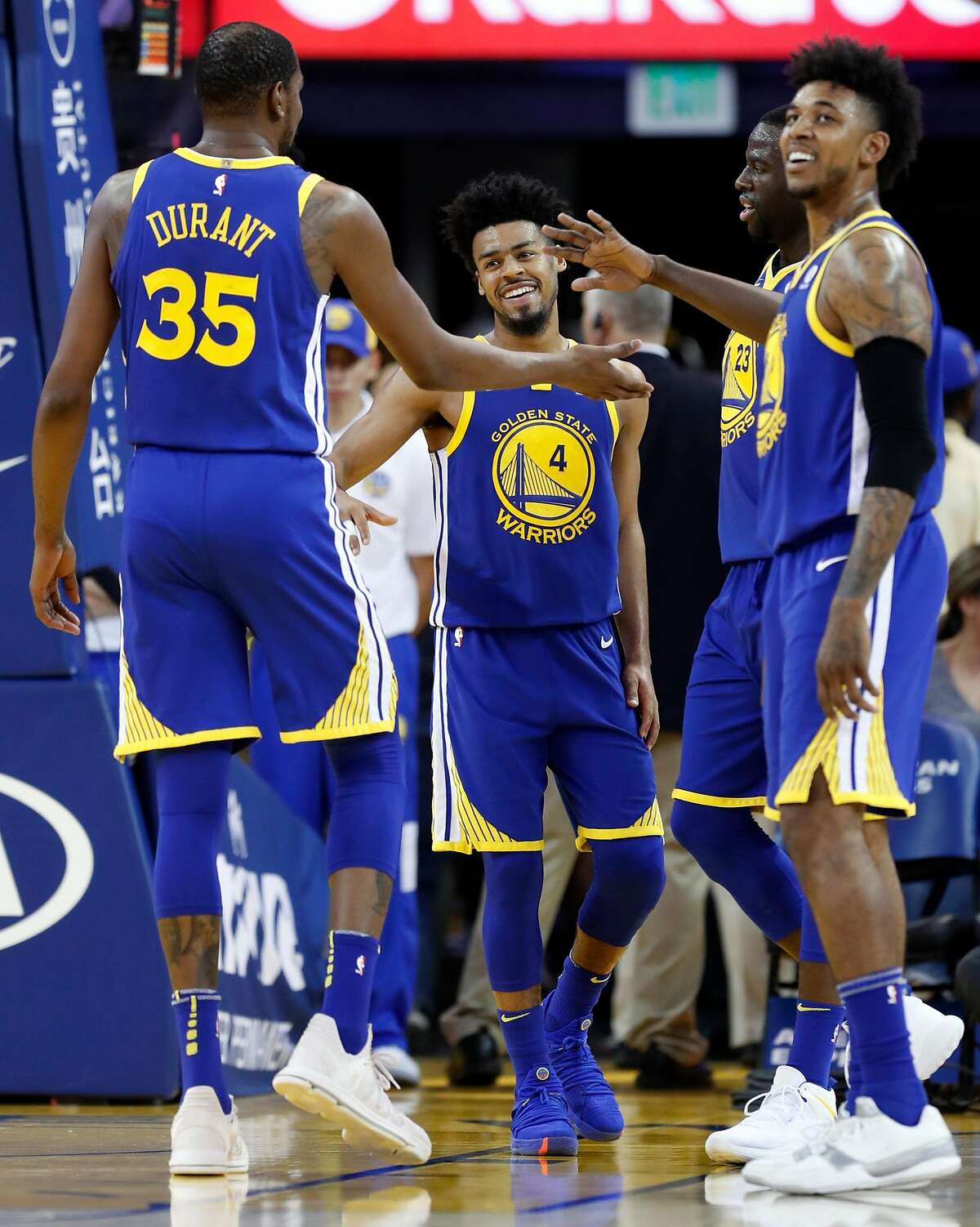 Golden State Warriors' Quinn Cook, Kevin Durant, Draymond Green and Nick Young enjoy themselves in 4th quarter of Warriors' 117-107 win over Phoenix Suns during NBA game at Oracle Arena in Oakland, Calif., on Sunday, April 1, 2018.