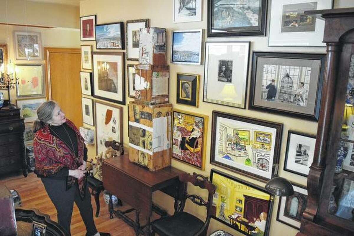 Allona Beasley Mitchell looks at some of her artwork that is on display in her new art studio at 602 E. State St., next to Lonzerotti’s Italia Restaurant.