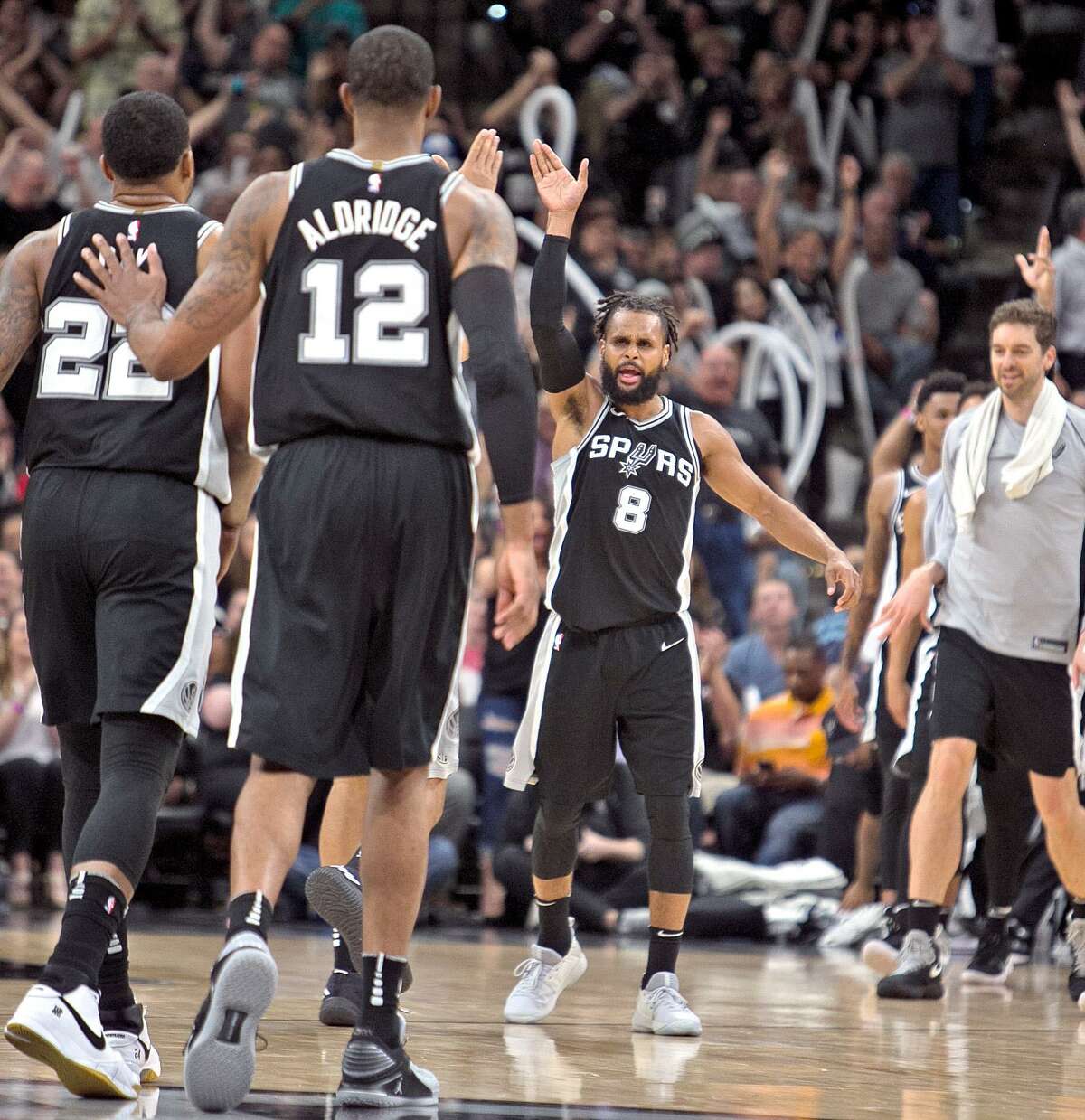 SAN ANTONIO,TX - APRIL 1 : Patty Mills #8 of the San Antonio Spurs celebrats with teammates after hitting a three at AT&T Center on April 1 , 2018 in San Antonio, Texas. NOTE TO USER: User expressly acknowledges and agrees that , by downloading and or using this photograph, User is consenting to the terms and conditions of the Getty Images License Agreement. (Photo by Ronald Cortes/Getty Images)