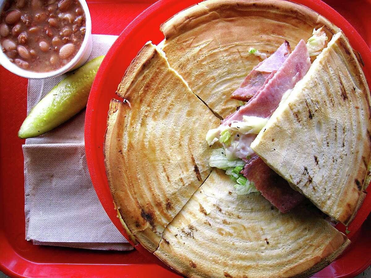 The Serious Sandwich at Zito’s Deli: How much does San Antonio love the Serious Sandwich at Zito’s? “That sandwich was an integral part of my childhood,” was just one of my social media interactions. The large Serious is as big as a steering wheel, built on a cross between a pizza crust and a giant communion wafer, cut into quarters and big enough for two ($16.98). The inside’s like an Italian muffuletta, anchored by black olive tapenade with salami, ham, provolone, cheddar, lettuce, tomato and Italian dressing. It’s a no-frills shop with that Northeastern brand of brusque, good-natured rudeness that builds fierce customer loyalty. 8800 Broadway, Suite 108, 210-826-4793, zitosdeli.net