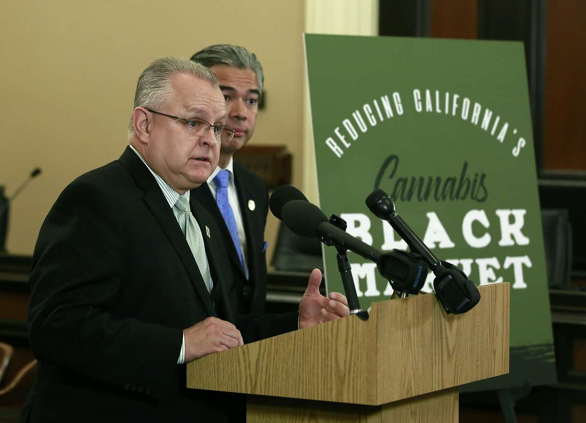 Assemblyman Tom Lackey, R-Palmdale, discusses the measure he and Assemblyman Rob Bonta, D-Oakland, right, are proposing to cut taxes on legal marijuana, Thursday, March 15, 2018, in Sacramento, Calif. The lawmakers say current taxes are so high that users often find it cheaper to keep buying illegal products from the black market. (AP Photo/Rich Pedroncelli)