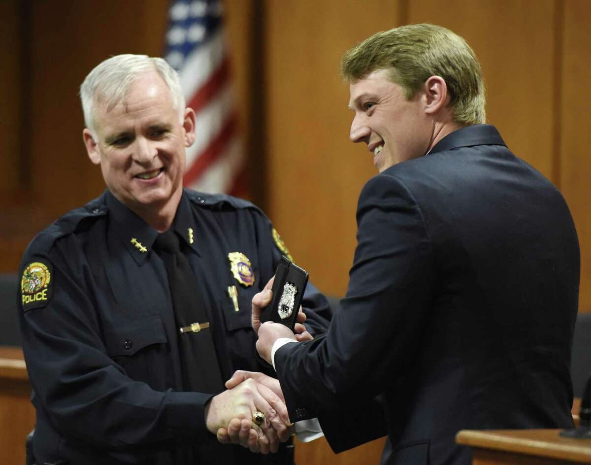 Police Chief James Heavey congratulates Steven Frano after he was sworn in as a Greenwich Police Officer at Town Hall in Greenwich, Conn. Monday, April 2, 2018. Frano will share the same badge number as his grandfather, John Frano, who was also a Greenwich police officer. Officer Brian Tornga was also promoted to Master Police Officer.