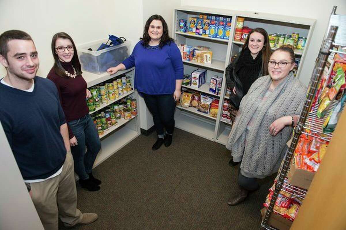 Saginaw Valley State University students have shown care and concern for their peers, working to establish a Cardinal Food Pantry to provide resources to hungry students. From left, Gerred Pease, a master of social work student from Midland; Shelby Myers, a social work major from Howell; Shelby Havens, a social work major from Snover; Katy Michaels, a social work from Howell, and Rustie Stebbins, a social work major from Saginaw. (Tim Inman/SVSU)