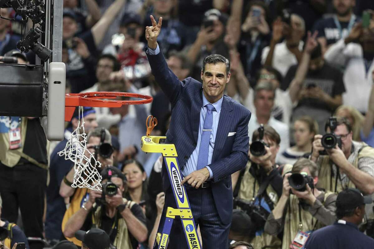 Villanova head coach Jay Wright waves the Villanova "V" to the fans after cutting the net after beating Michigan to win the NCAA National Championship at the Alamodome Monday, April 2, 2018 in San Antonio, Texas. Villanova are National Champions, beating Michigan 79-62. (Steven M. Falk/Philadelphia Inquirer/TNS)