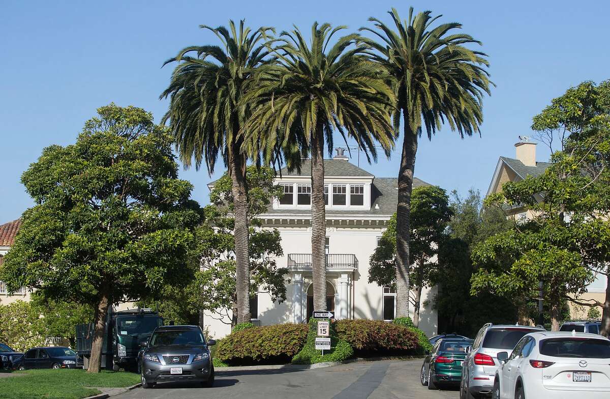Large palm trees and other greenery sit on an island amongst homes at 1 Presidio Terrace seen Tuesday, April 3, 2018 in San Francisco, Calif.