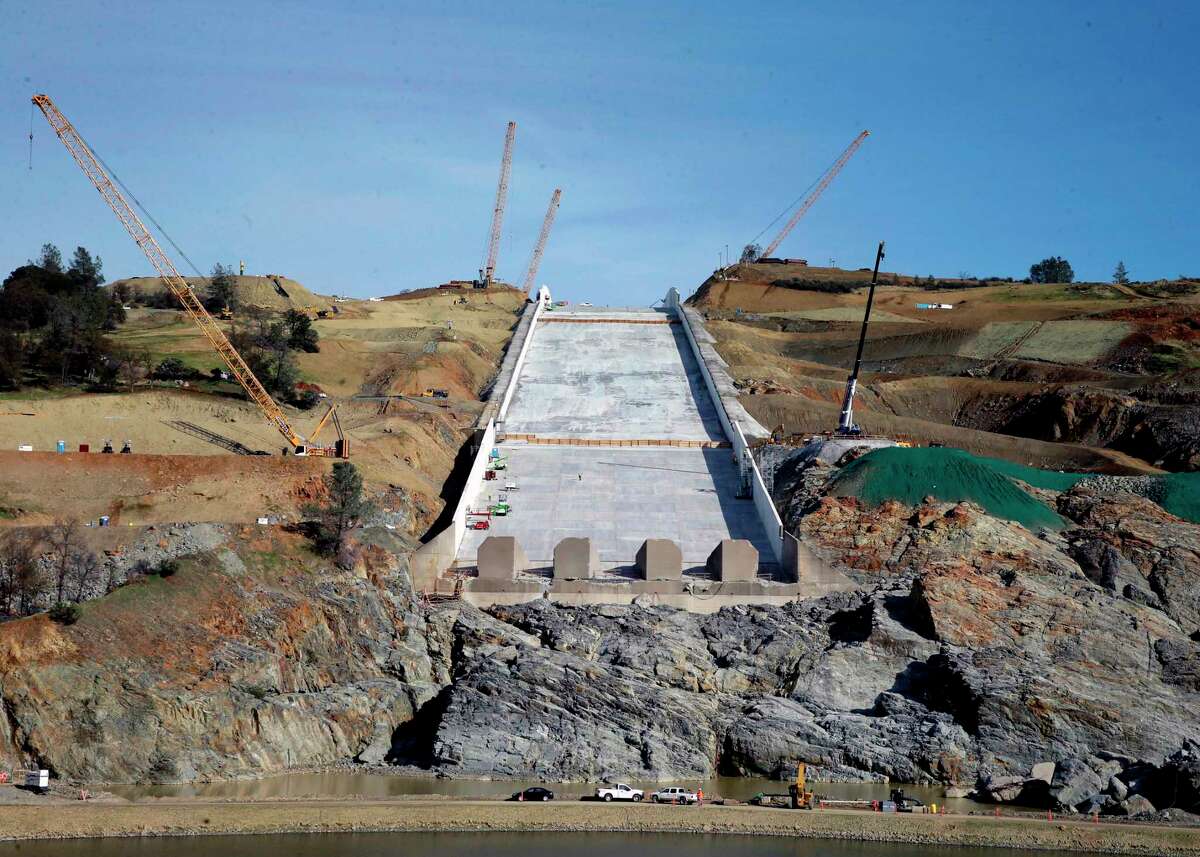 FILE--In this Nov. 30, 2017, file photo, work continues on the Oroville Dam spillway, in Oroville, Calif. California water officials say they may have to use the partially rebuilt spillway at Oroville Dam for the first time since they began repairs to the badly damaged structure last summer. Department of Water Resources officials said Tuesday, April 3, 2018, that anticipated storms could send trigger releases this week or next.