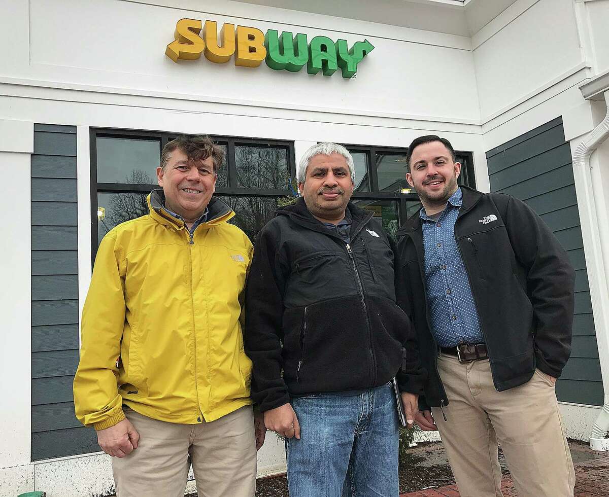 John Palumbo, director of construction for Subway; Ashwin Patel, franchise owner; and Chris Fraulo, business consultant for Subway, in front of the Fresh-Forward design Subway that will open later this month in Brookfield Village.