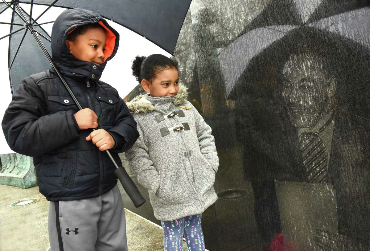 Kenzo Abdul-Aziz, 7, of Rotterdam and his sister Aaliyah, 4, look at an etching of Rev. Martin Luther King Jr. giving his Nobel Prize Acceptance Speech in 1964 in Norway at the Rev. Martin Luther King Statue in Lincoln Park on Wednesday, April 5, 2018 in Albany, N.Y. Capital Region members of the Alpha Phi Alpha Fraternity held an "Omega Service" commemorating the 50th anniversary of Martin Luther King Jr. assassination on National Day of Action at the statue.(Lori Van Buren/Times Union)