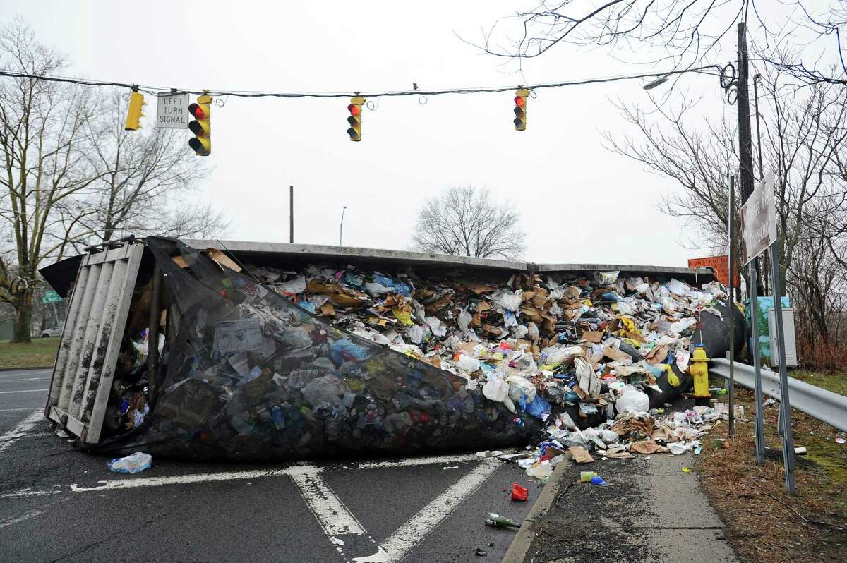 A city garbage truck rolled over at the intersection of East Main St. and Seaside Ave. at noon on Wednesday, April 4, 2018 in Stamford, Conn.