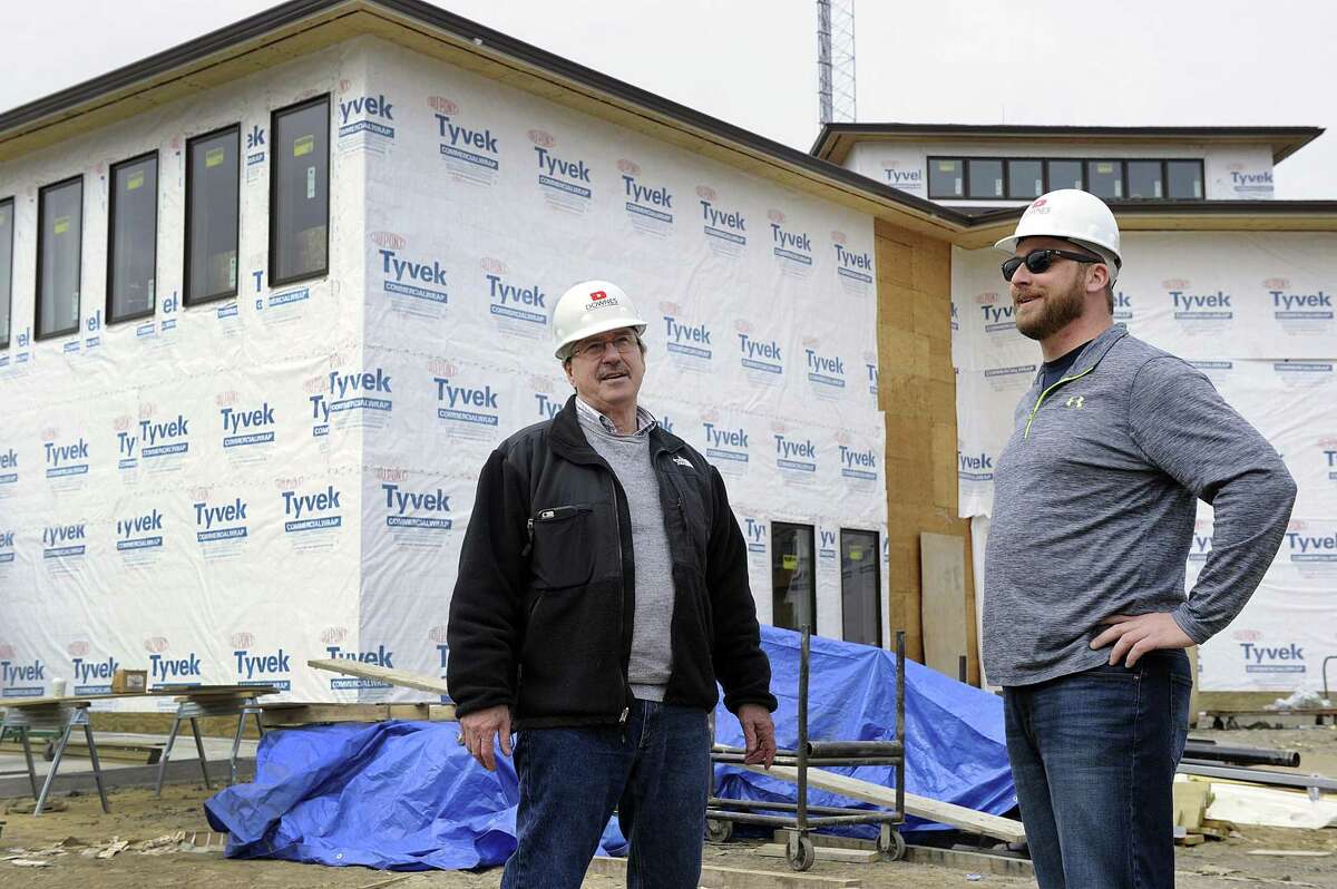 Jon Menti, left, chairman of the public site and building commission for Bethel, and commission member Josh Adams, check out the progress of the new Bethel Police Headquarters Wednesday, March 28, 2018. The project is more than $888,000 over budget.