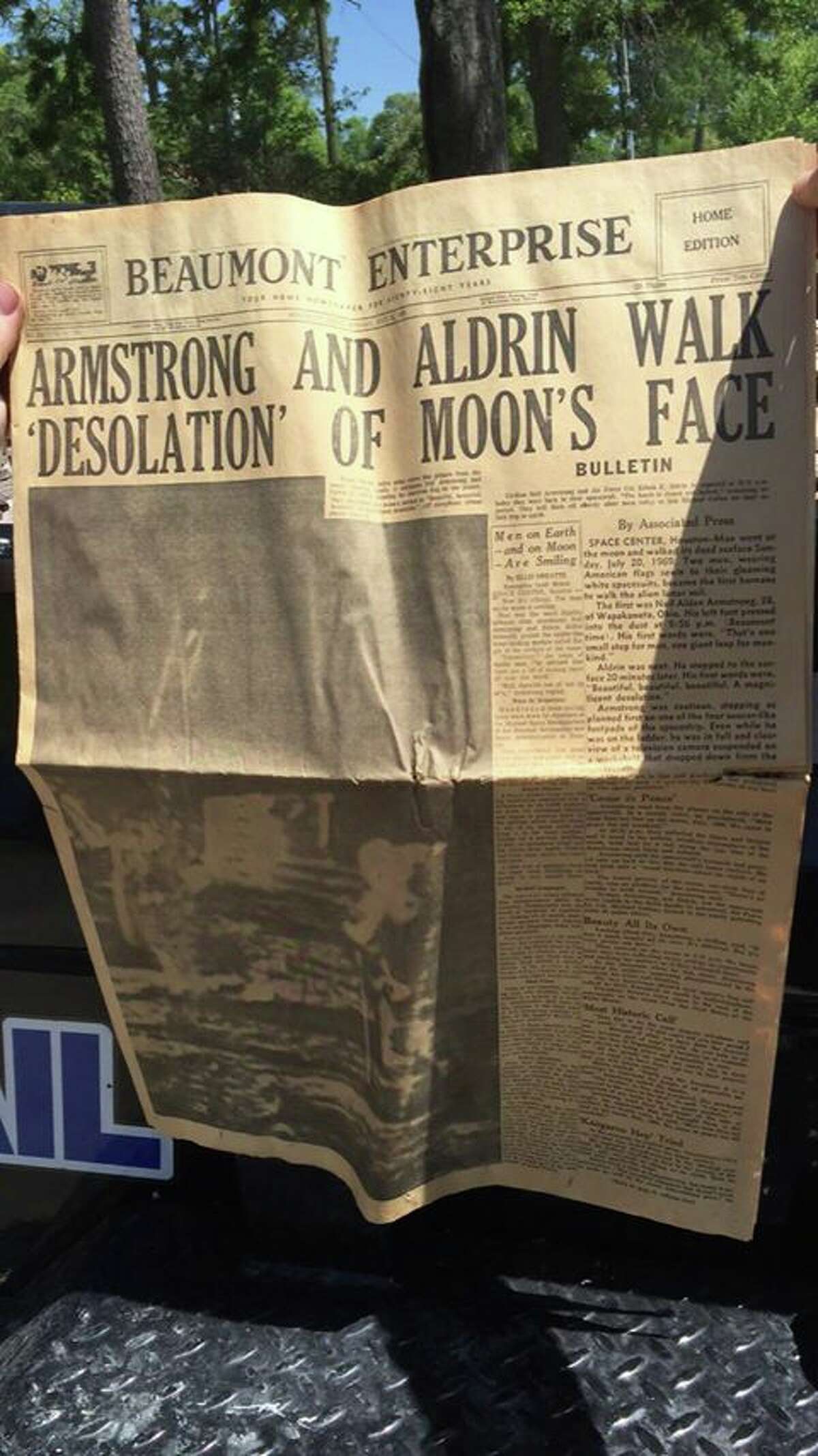 Dustyn Myatt, of Kirbyville, holds up a copy of the Beaumont Enterprise, dated July 21, 1969, reporting the news of astronauts Neil Armstrong and Edwin "Buzz" Aldrin's landing and walking on the moon. The headline read, "Armstrong and Aldwin walk 'desolation' of moon's face." Myatt, a demolition contractor, discovered the newspaper in a stash while working on a home Wednesday in Vidor. (Dustyn Myatt/Special to The Enterprise)