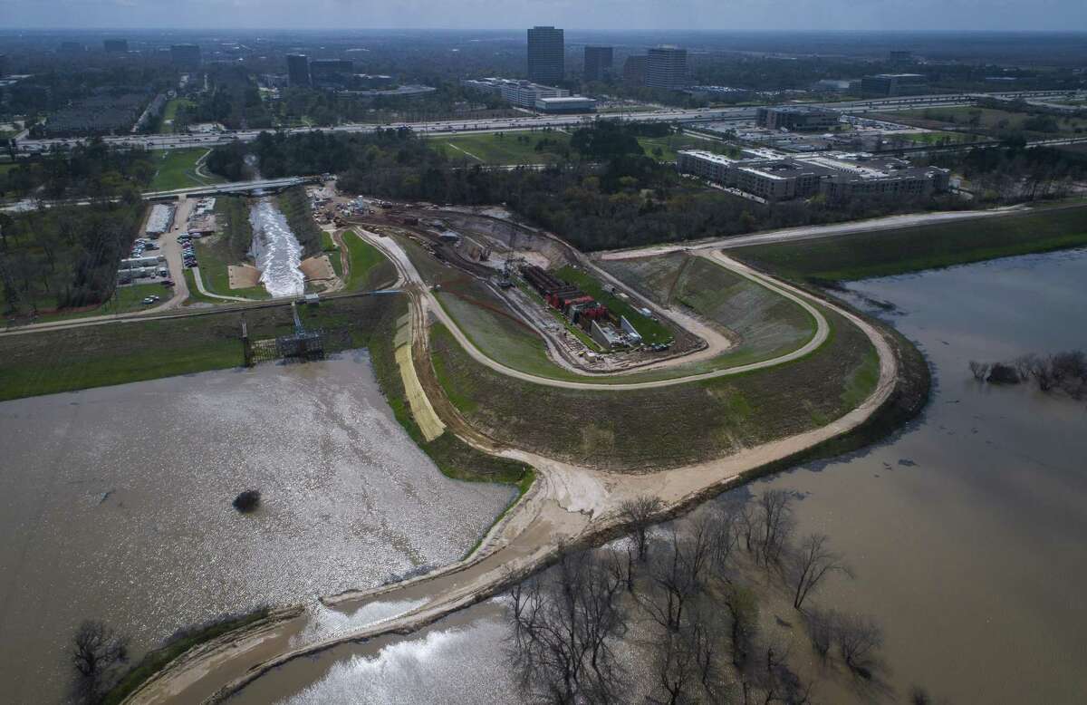 Water flows out of the Addicks Reservoir down the main spillway near N. Eldridge Pkwy., Wednesday, Feb. 28, 2018, in Houston. A coffer dam is in place where the Army Corps of Engineers is building a new spillway. ( Mark Mulligan / Houston Chronicle )