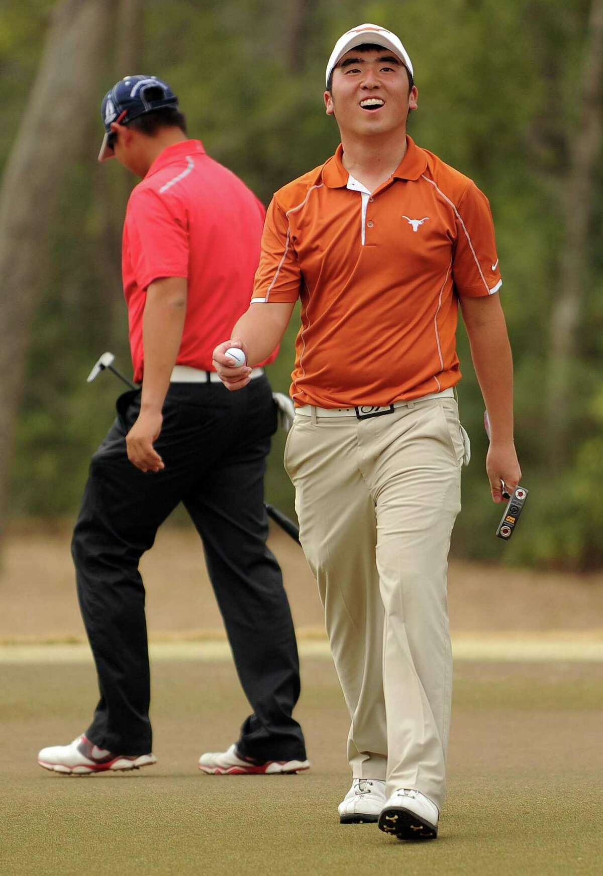 Doug Ghim, right, walks off the No. 17 green after getting up and down for par during the final round of the CB&I Boys Championship, Monday, February 17, 2014, at The Club at Carlton Woods' Fazio Championship Course in The Woodlands. Ghim won the tournament by five strokes over Carl Yuan and Andy Zhang.