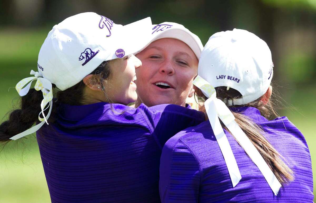 Hailee Cooper of Montgomery is mobbed by teammates after finishing first overall at -9 par and helping the Lady Bears to a team title during the final round of the District 12-6A golf tournament at High Meadow Ranch, Wednesday, April 4, 2018, in Magnolia.