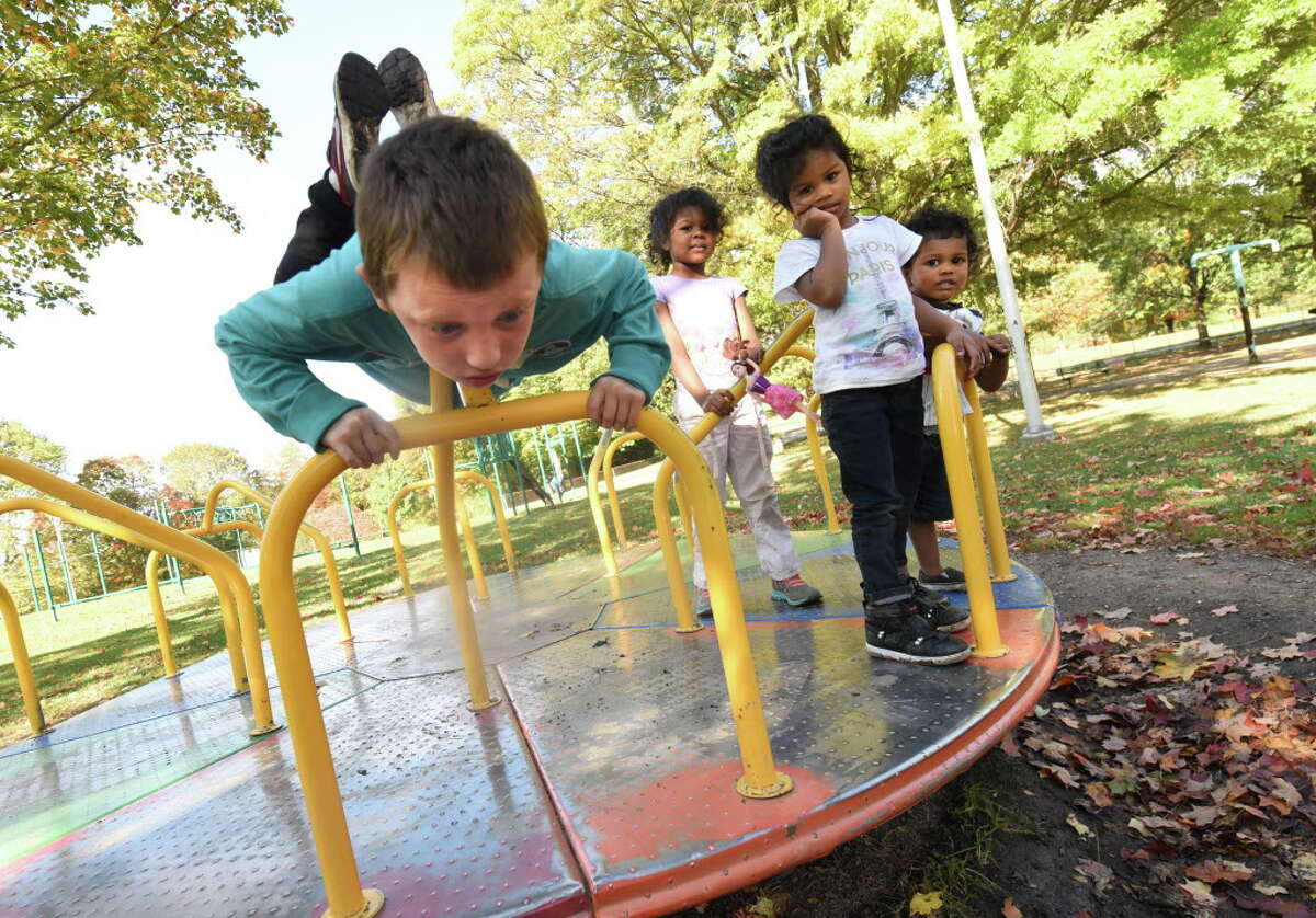 Kids play on a merry-go-round on a playground in Frear Park on Tuesday, Oct. 10, 2017 in Troy, N.Y. (Lori Van Buren / Times Union)